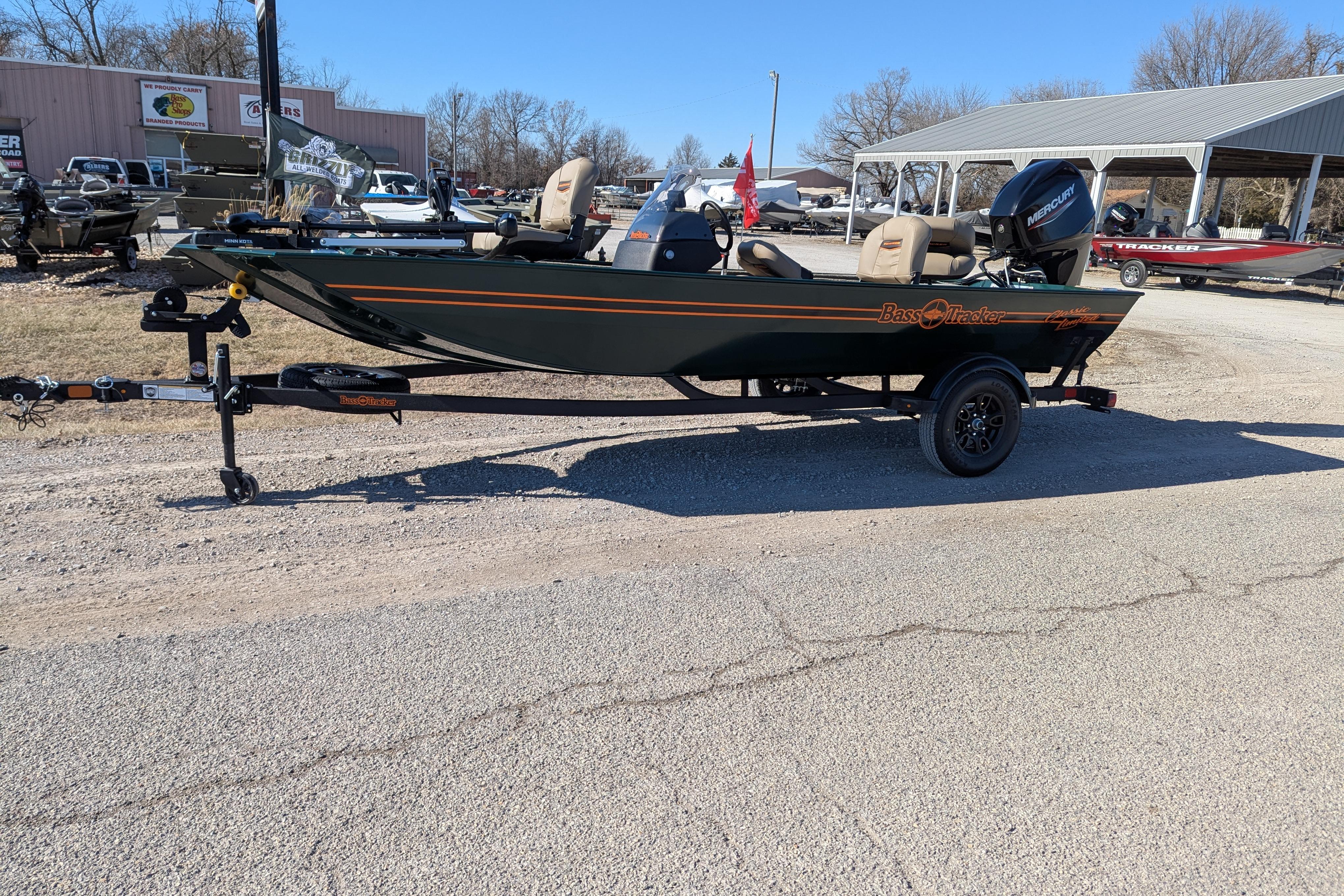2025 Tracker Bass Tracker Classic Limited boat on trailer in outdoor dealership lot.