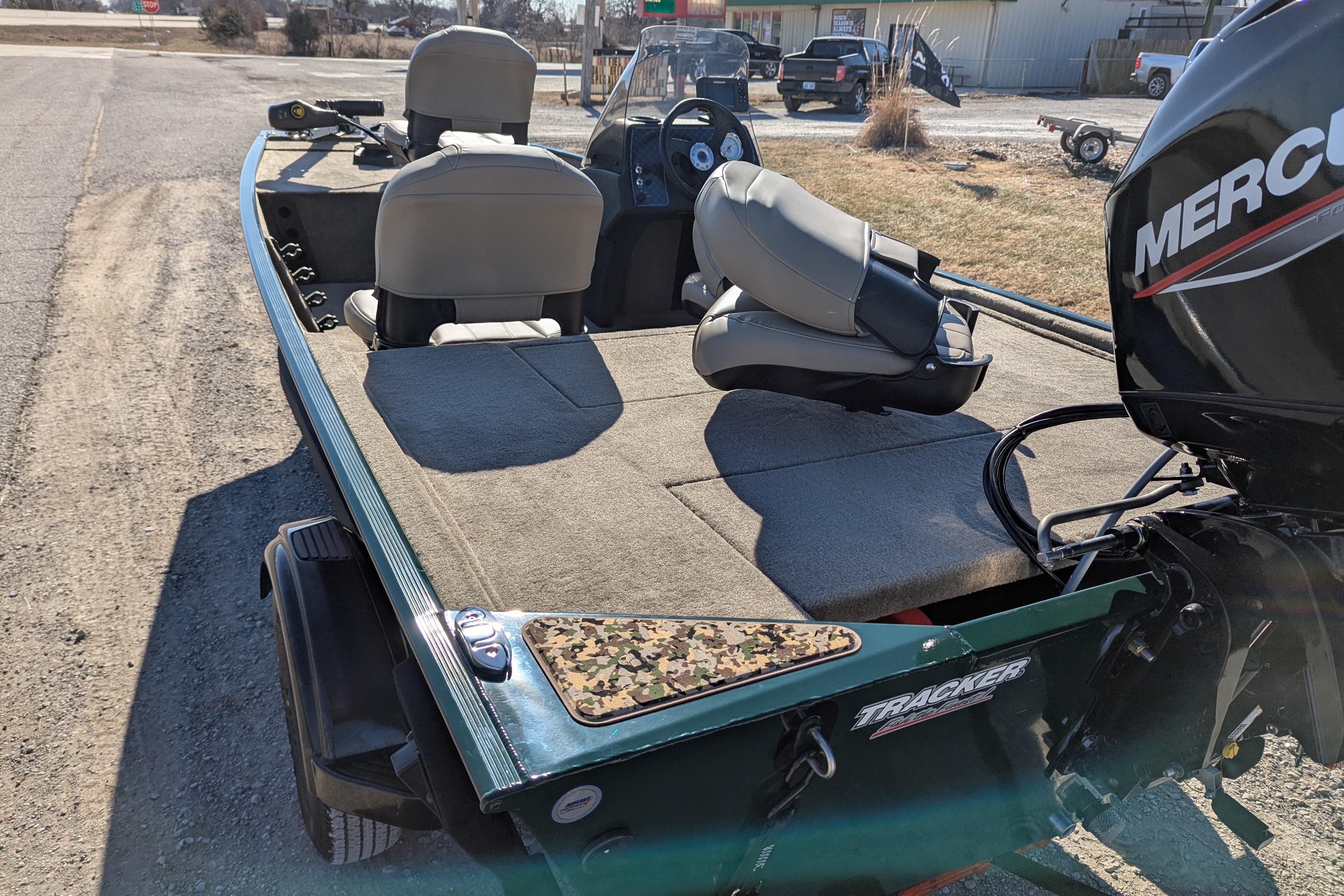 2025 Tracker Bass Tracker Classic Limited boat with Mercury engine, parked outdoors.