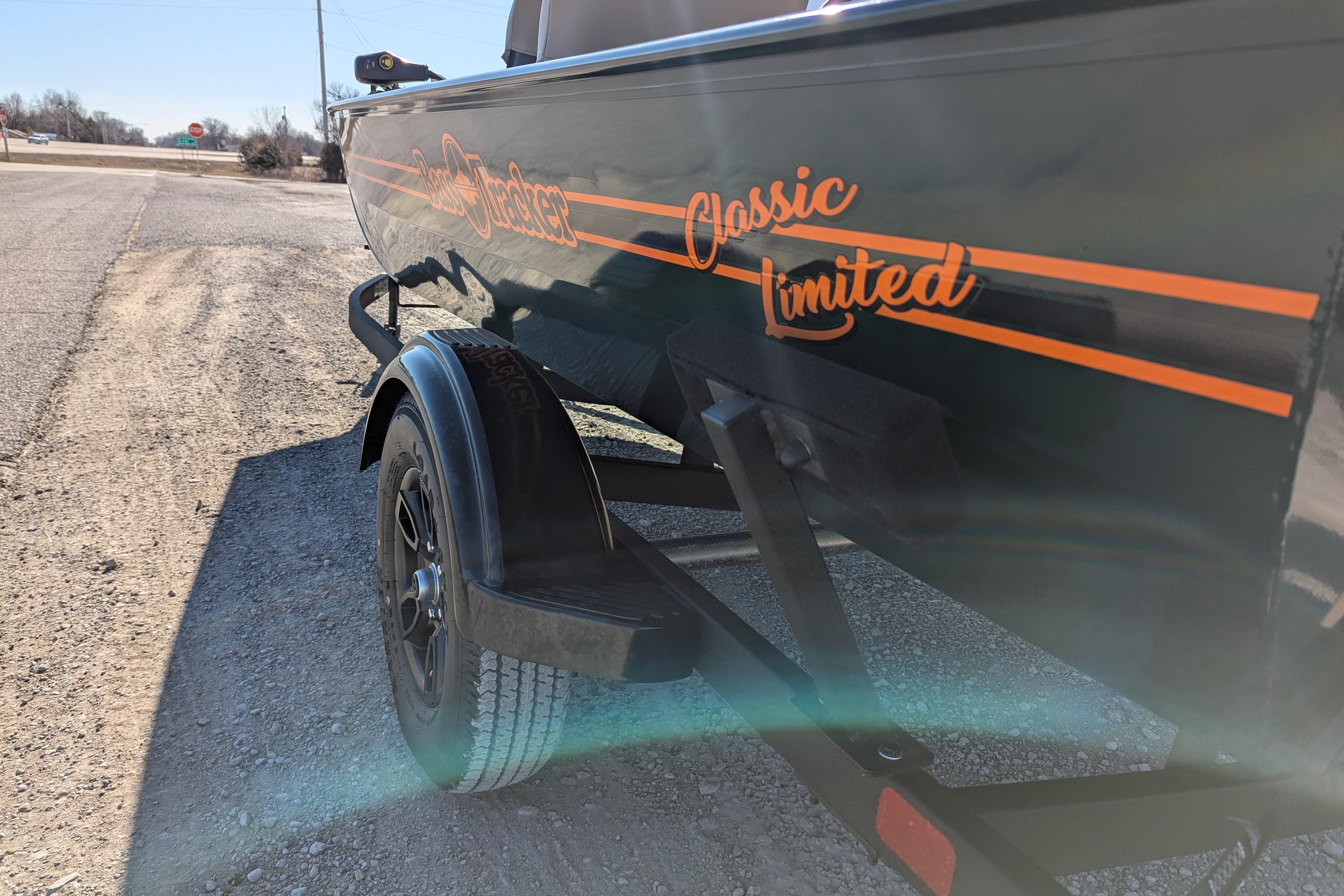 2025 Tracker Bass Tracker Classic Limited boat on trailer, parked on gravel road.