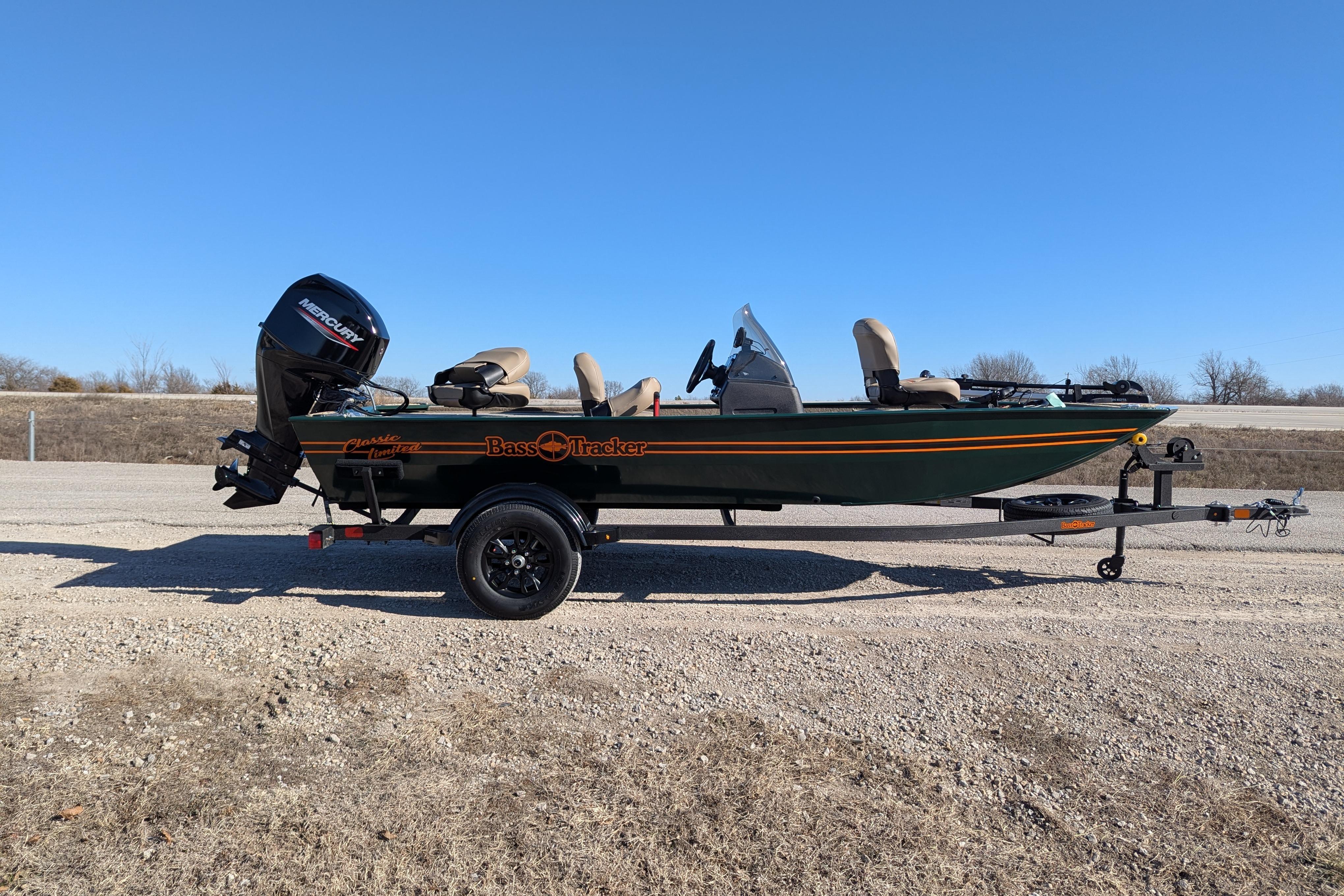 2025 Tracker Bass Tracker Classic Limited boat on trailer, parked on gravel road.