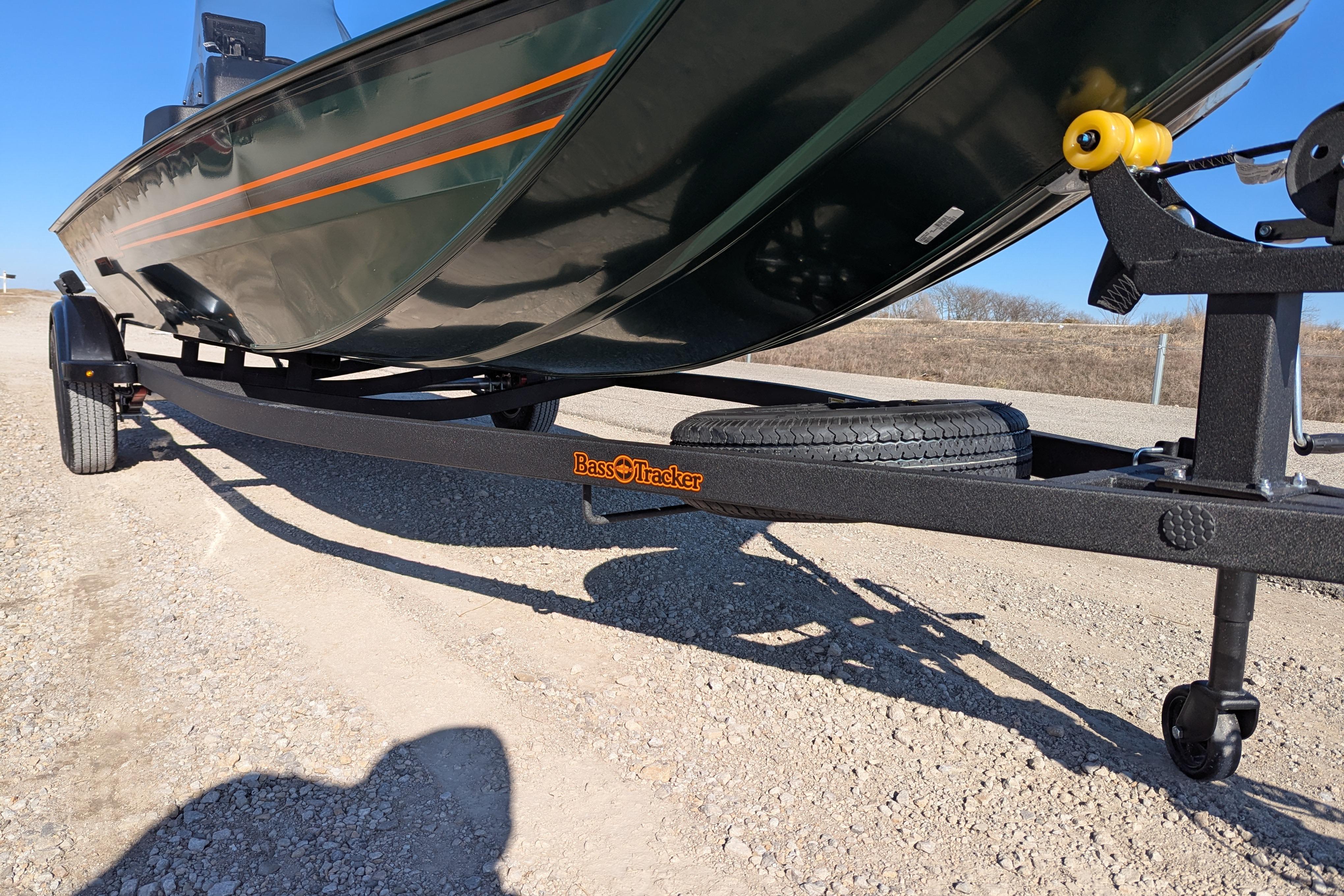 2025 Tracker Bass Tracker Classic Limited boat on trailer, parked on gravel road.