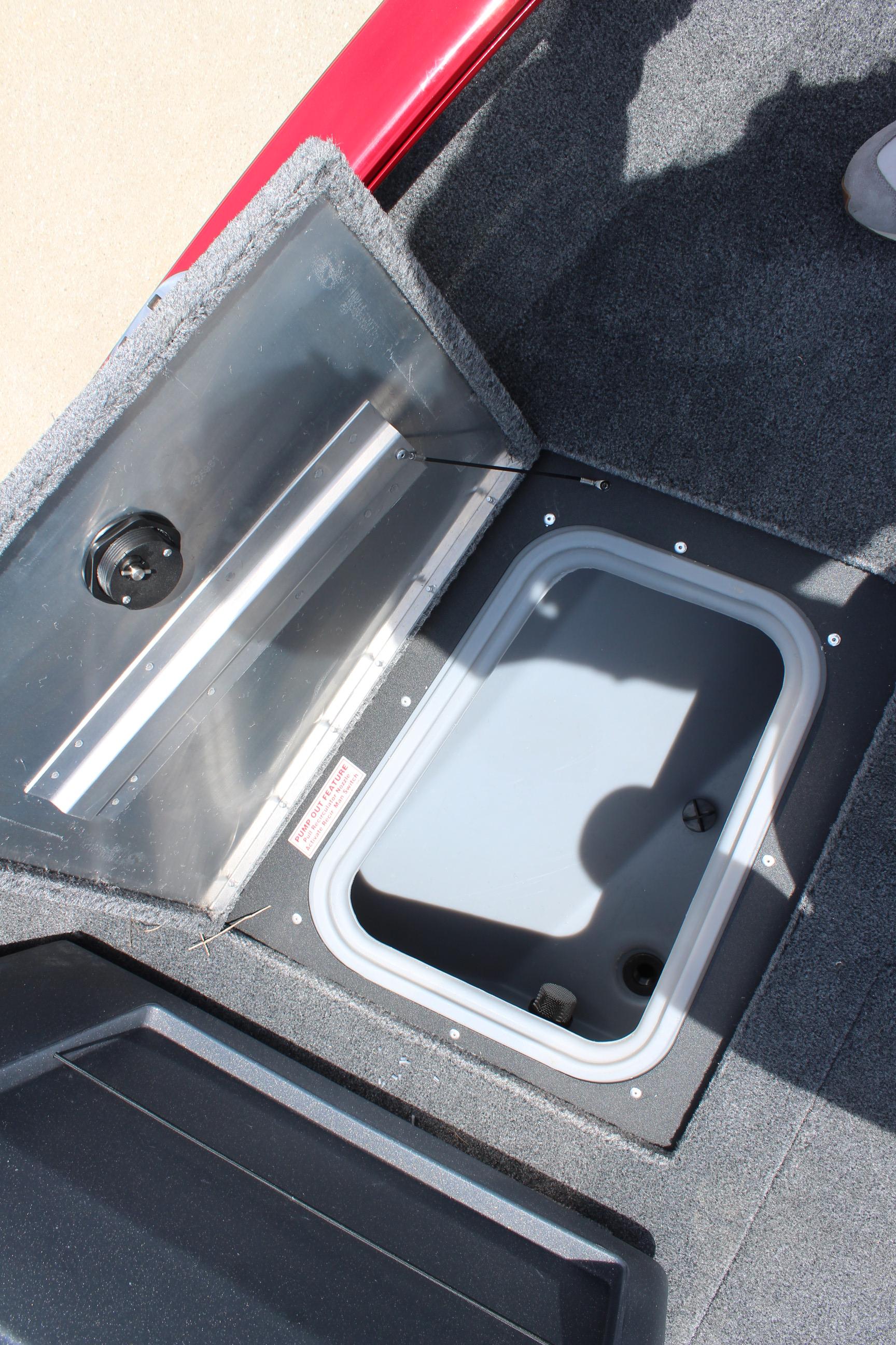 2025 Tracker Pro Guide V-175 Combo boat storage compartment, open lid, carpeted interior.