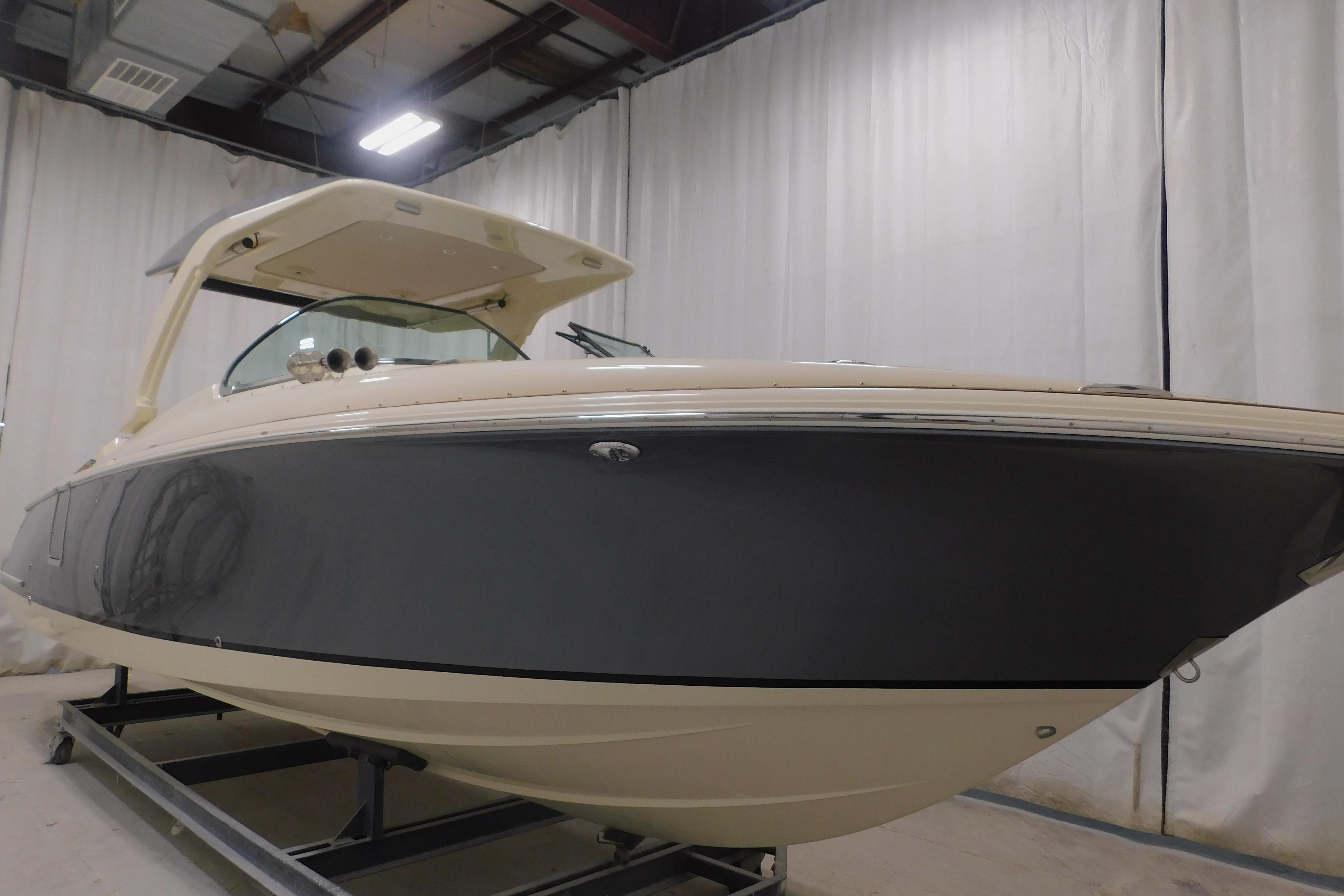 2024 Chris-Craft Launch 31 GT boat in indoor showroom, side view.