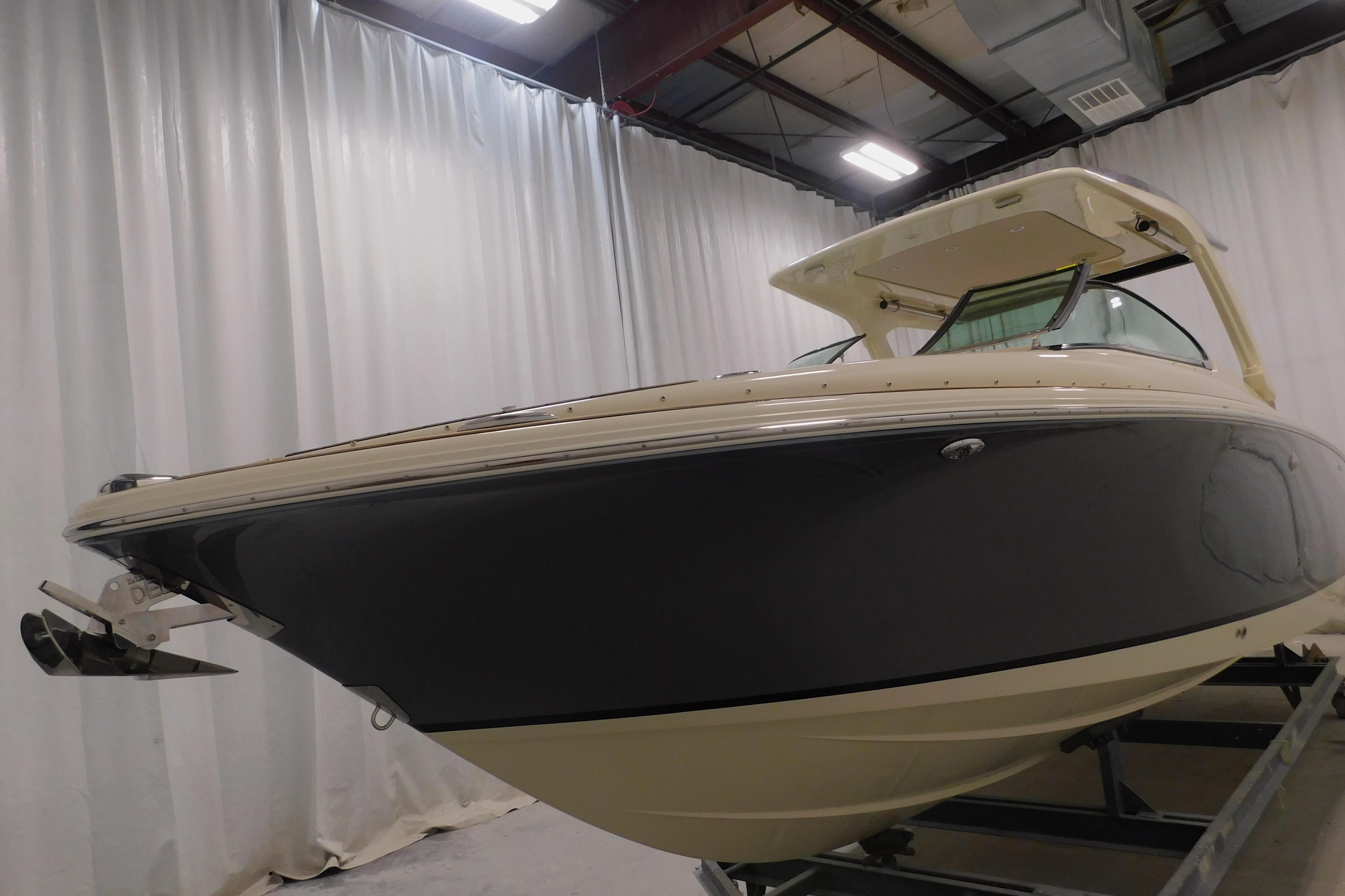 2024 Chris-Craft Launch 31 GT boat in showroom, side view.