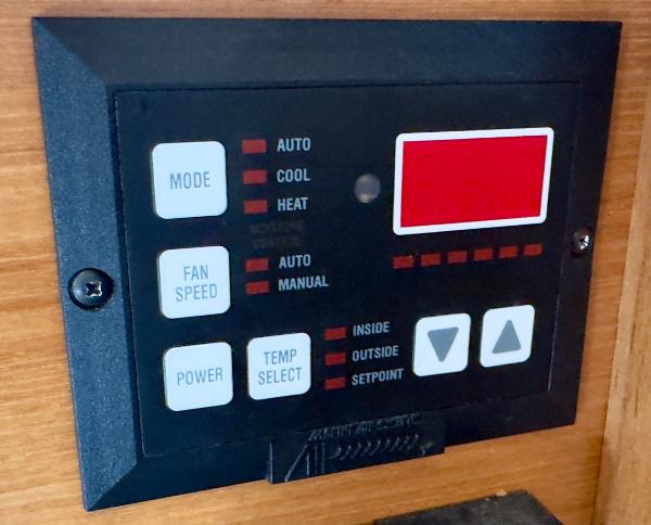 Control panel of a 1998 Bayliner 3388 Command Bridge Motoryacht, featuring mode and temperature settings.
