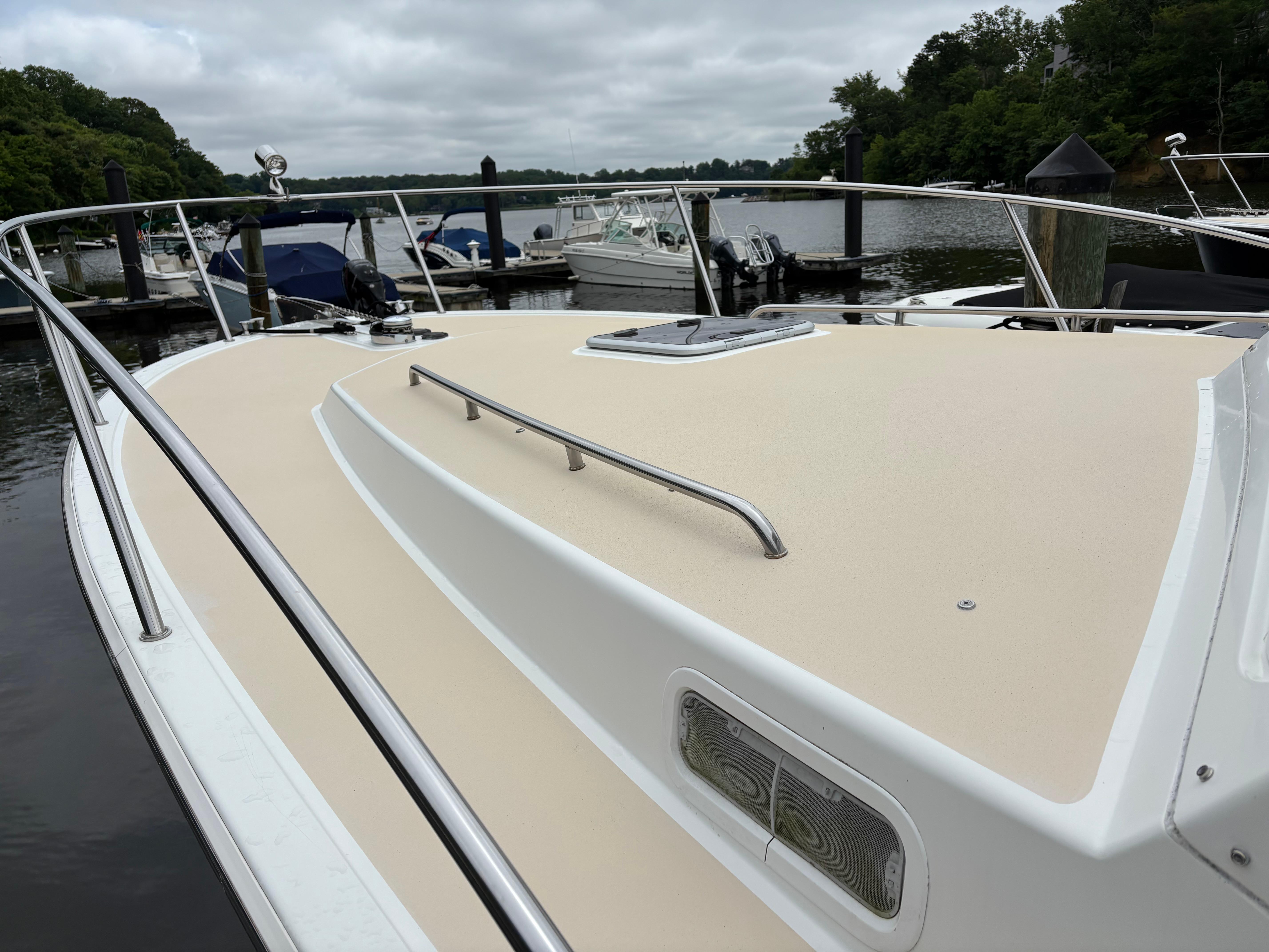 MJM-34z Express HT 2006-Zest MD-US-2006 MJM 34z Express HT boat docked at a marina, featuring a spacious deck.-9817750 | Thumbnail