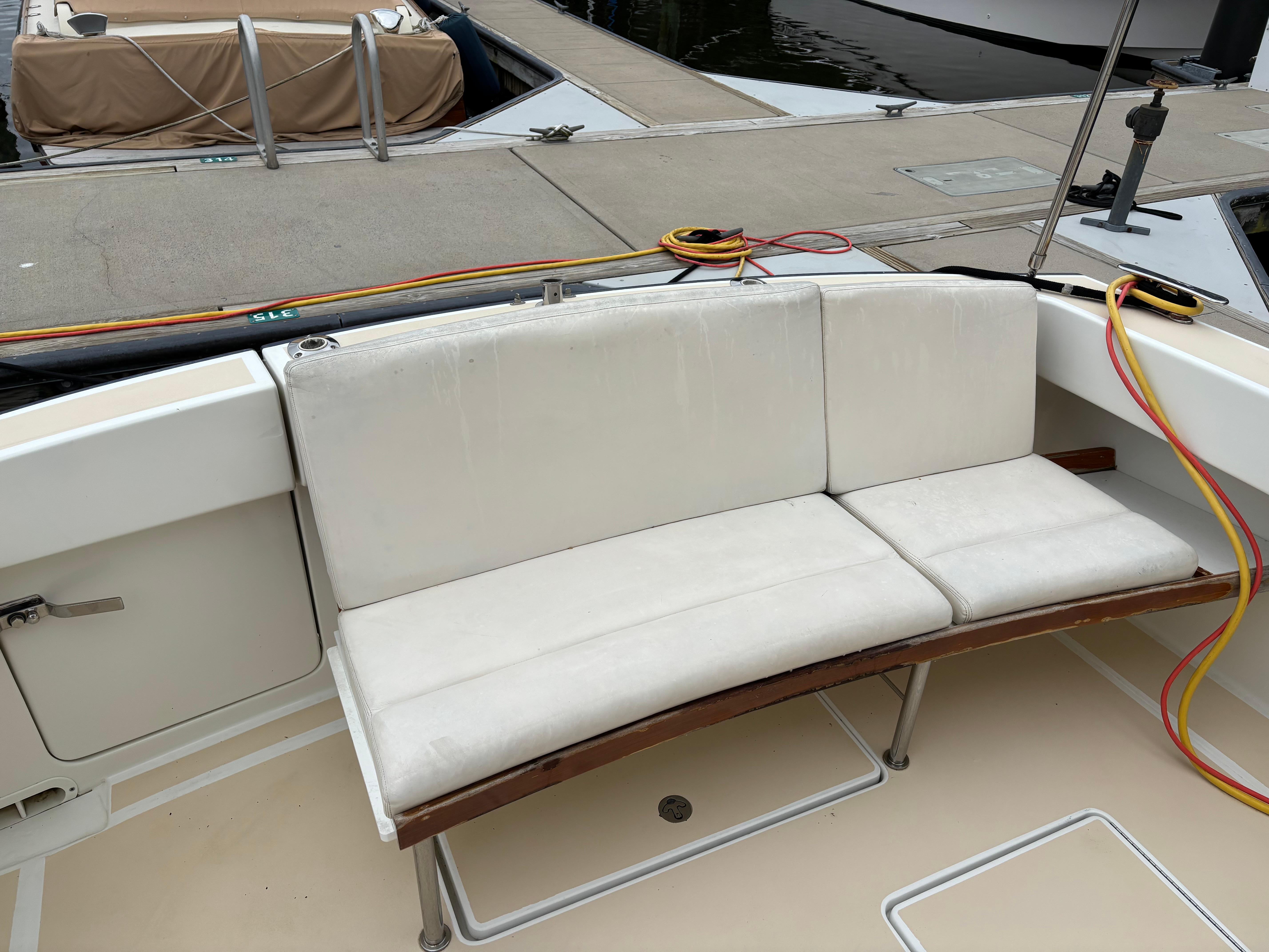MJM-34z Express HT 2006-Zest MD-US-2006 MJM 34z Express HT boat with white cushioned seating at the dock.-9817750 | Thumbnail