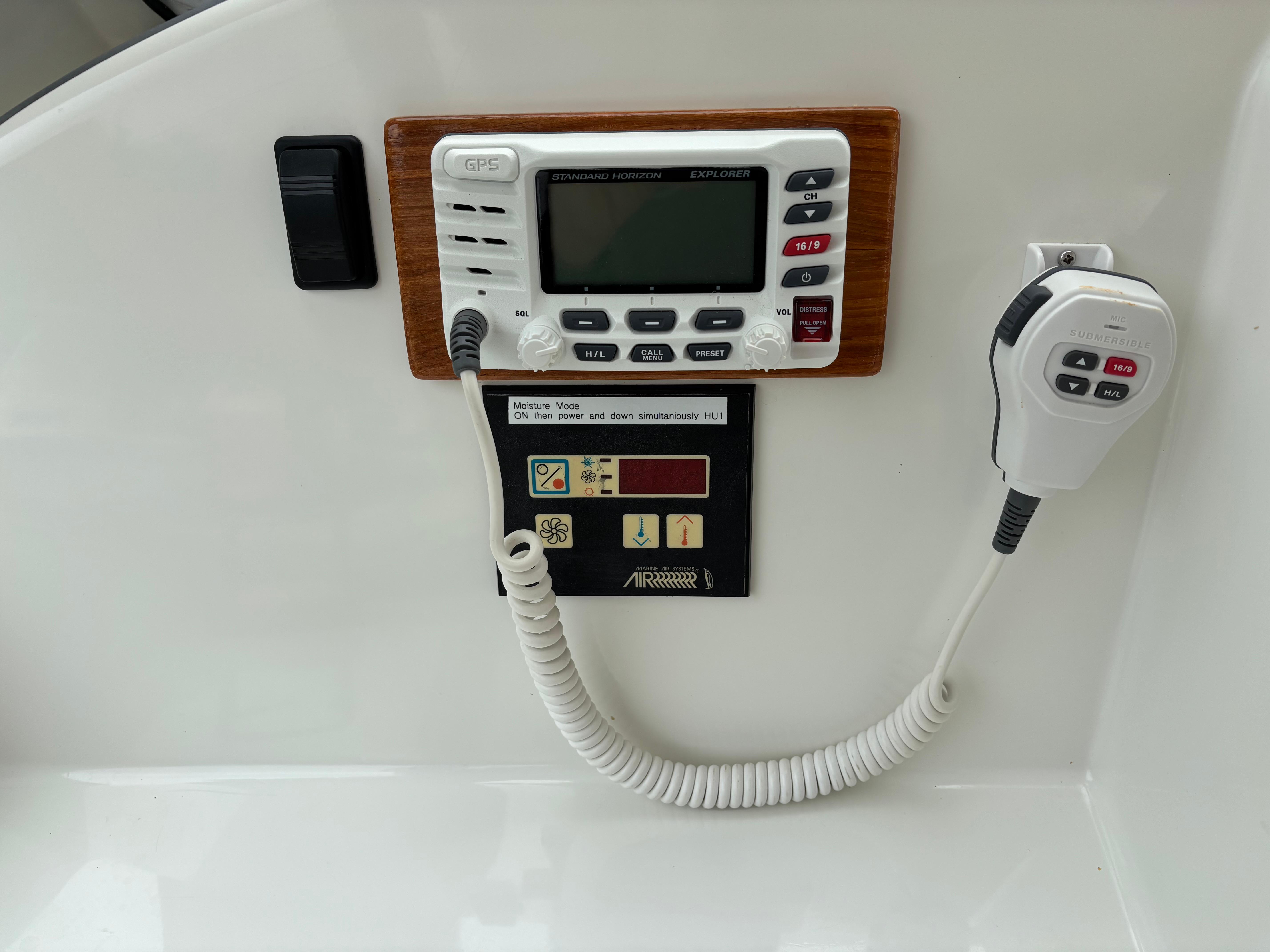 MJM-34z Express HT 2006-Zest MD-US-Control panel of a 2006 MJM 34z Express HT boat with radio and microphone.-9817750 | Thumbnail