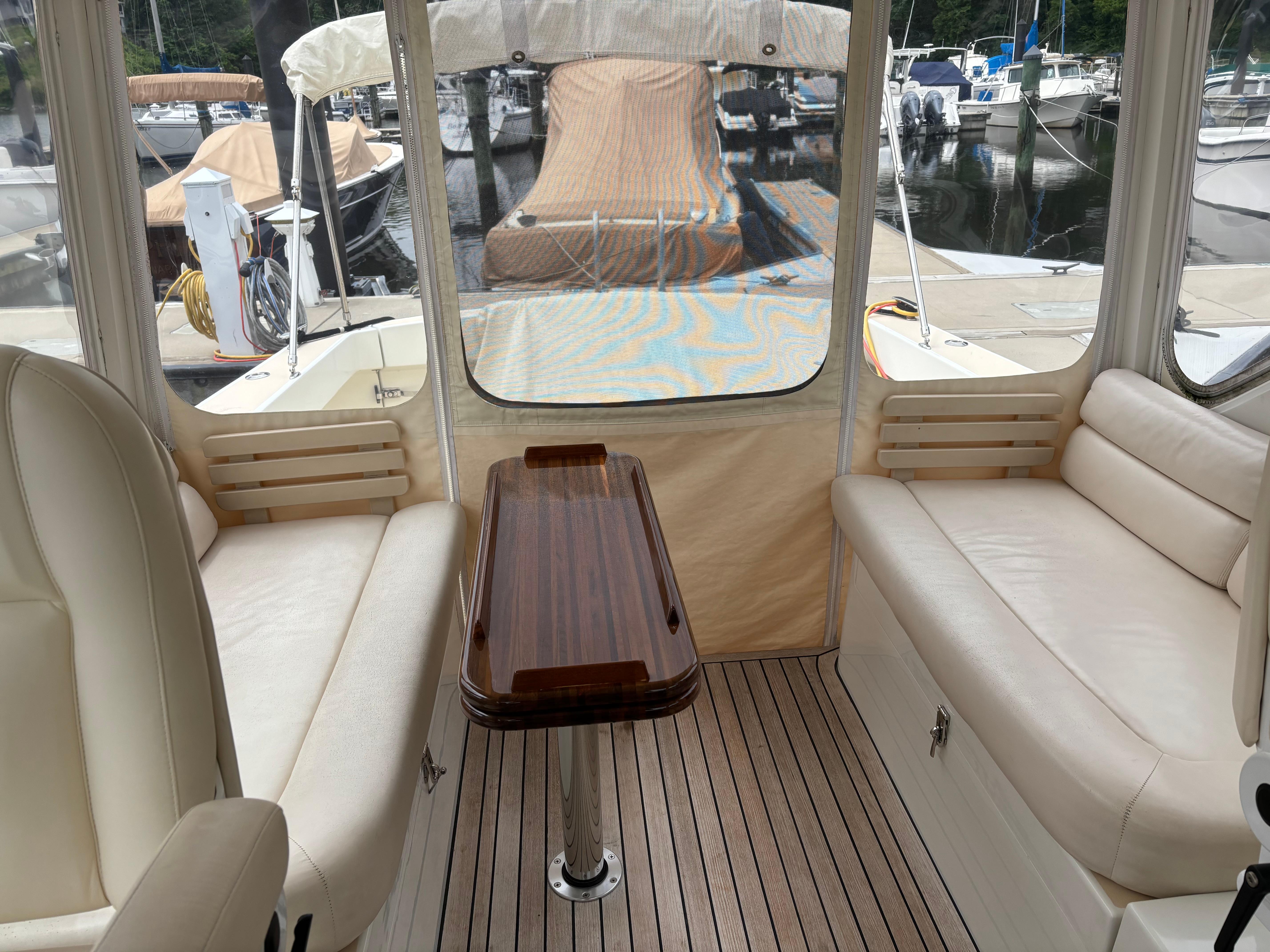 MJM-34z Express HT 2006-Zest MD-US-Interior of 2006 MJM 34z Express HT boat with beige seating and wooden table.-9817750 | Thumbnail
