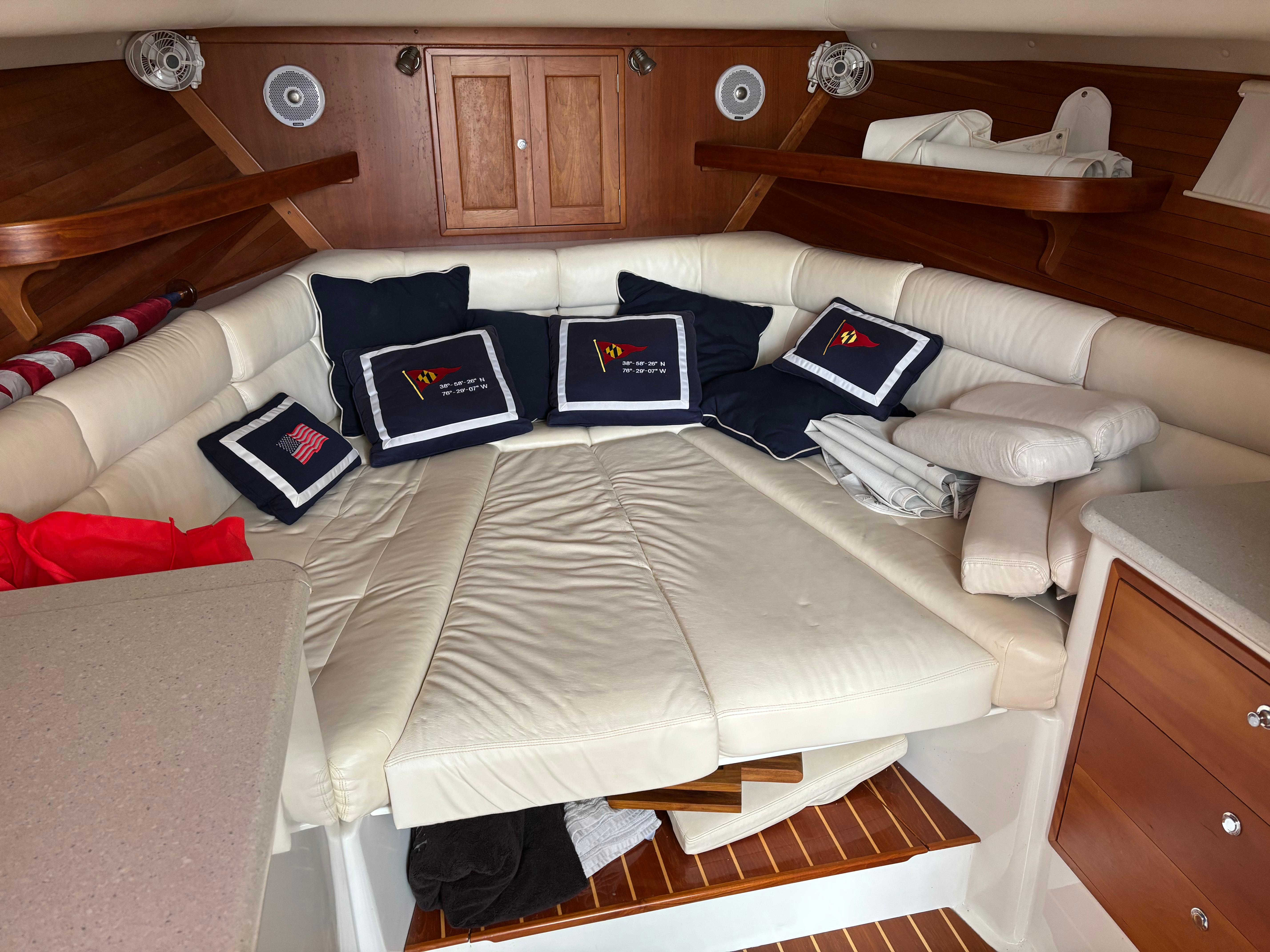 MJM-34z Express HT 2006-Zest MD-US-2006 MJM 34z Express HT cabin with white leather seating and nautical-themed cushions.-9817750 | Thumbnail