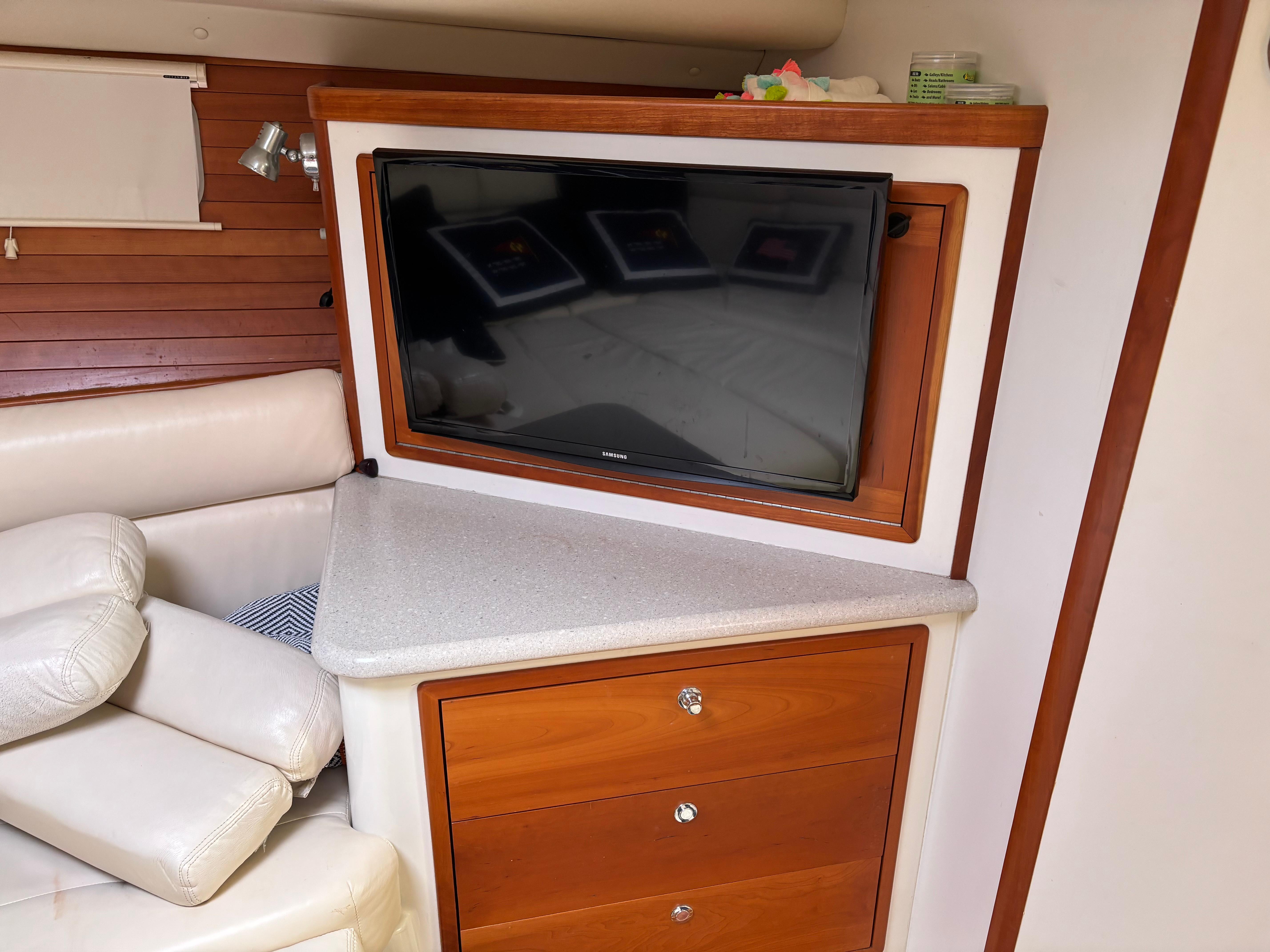 MJM-34z Express HT 2006-Zest MD-US-Interior of 2006 MJM 34z Express HT with TV, wooden cabinetry, and cream seating.-9817750 | Thumbnail