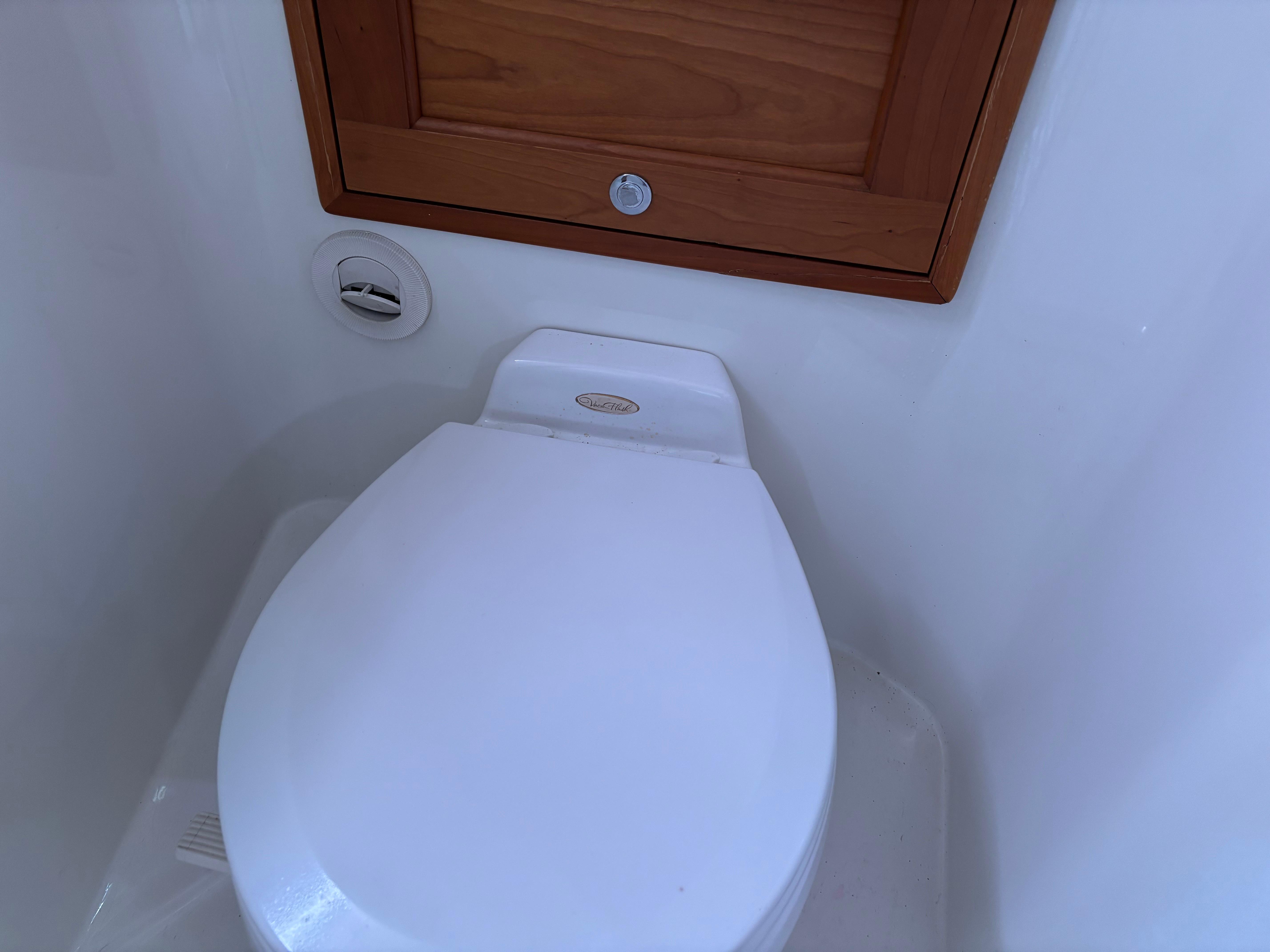 MJM-34z Express HT 2006-Zest MD-US-Toilet in 2006 MJM 34z Express HT boat bathroom, featuring wooden cabinet.-9817750 | Thumbnail