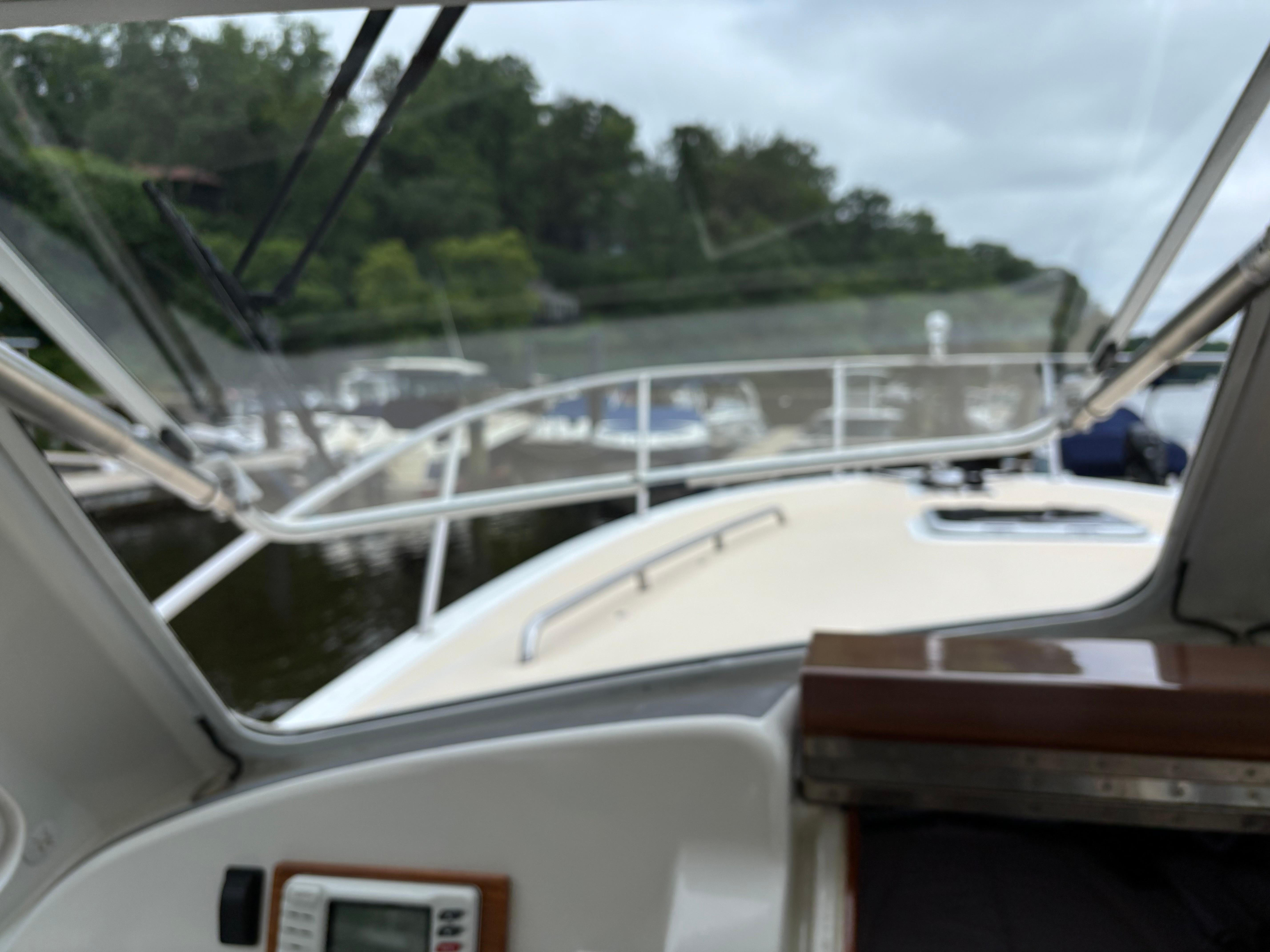 MJM-34z Express HT 2006-Zest MD-US-2006 MJM 34z Express HT boat interior view with windshield and docked boats.-9817750 | Thumbnail