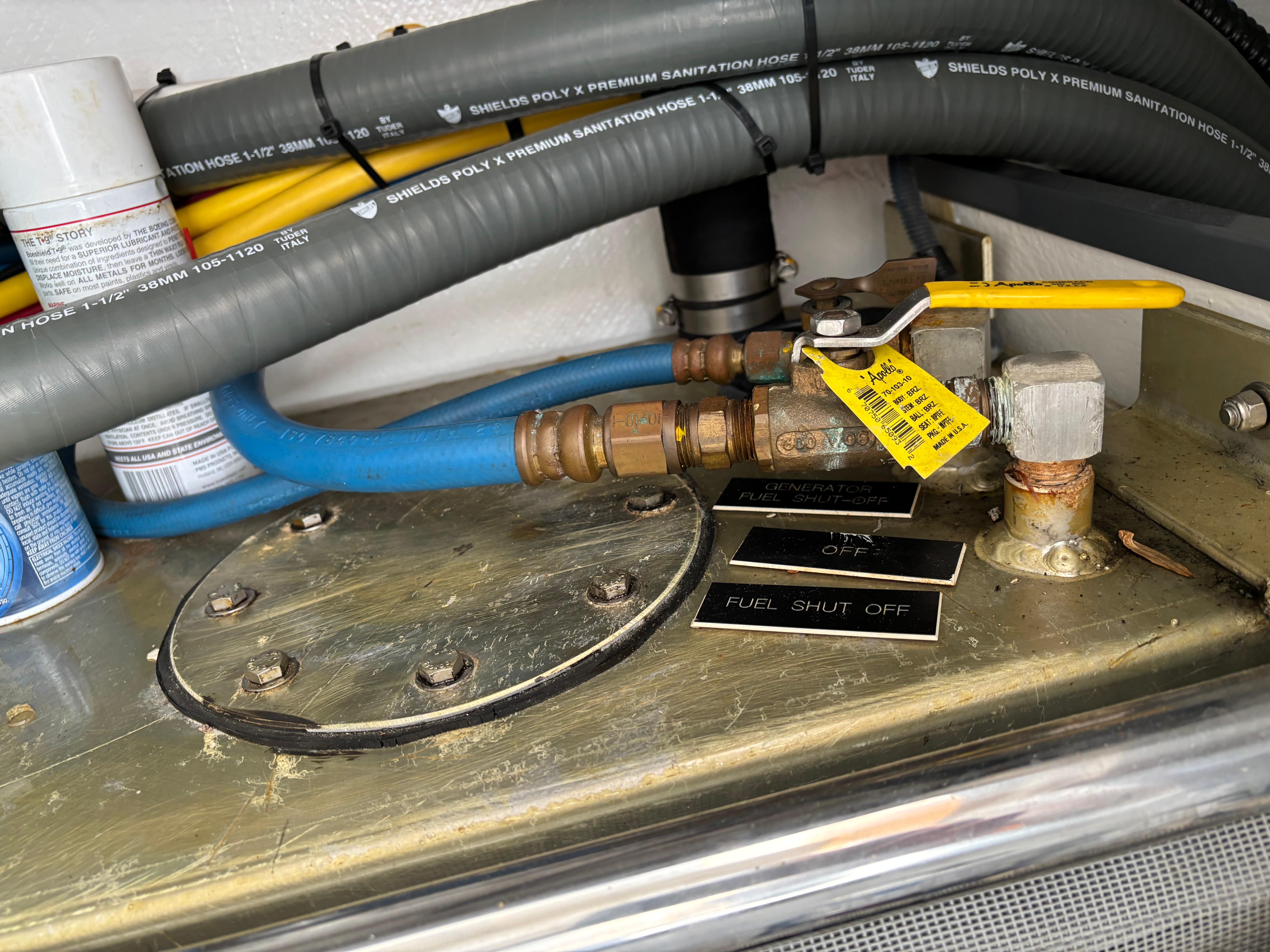 MJM-34z Express HT 2006-Zest MD-US-Fuel shut-off valve on a 2006 MJM 34z Express HT boat, with hoses and labels.-9817750 | Thumbnail