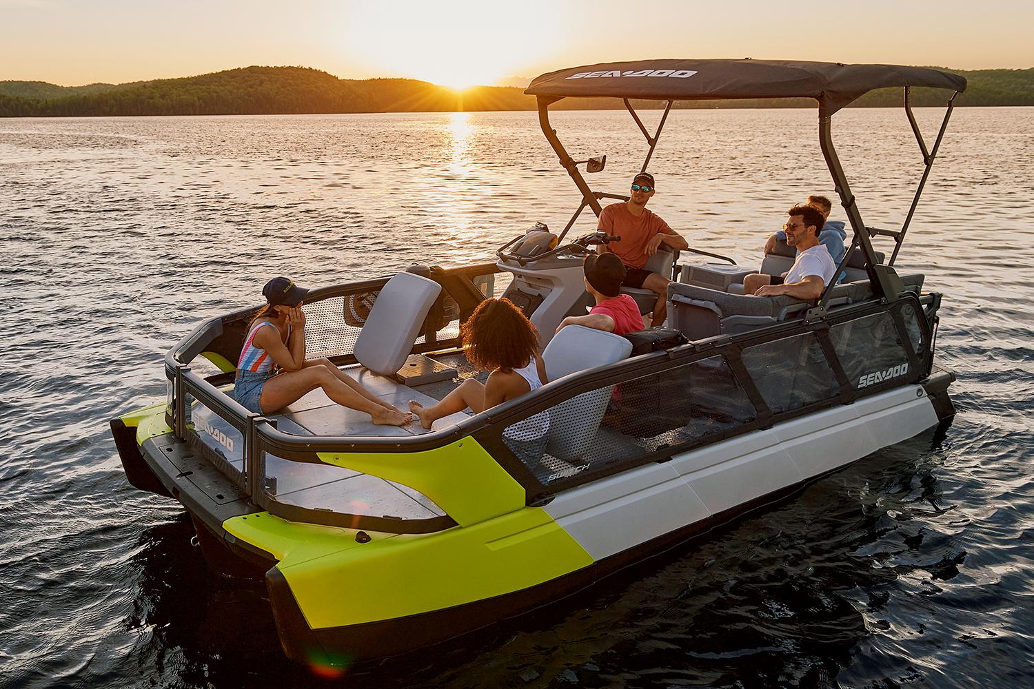 Manufacturer Provided Image: 2022 Sea-Doo Switch Sport 21 pontoon boat with people enjoying a sunset on the water.