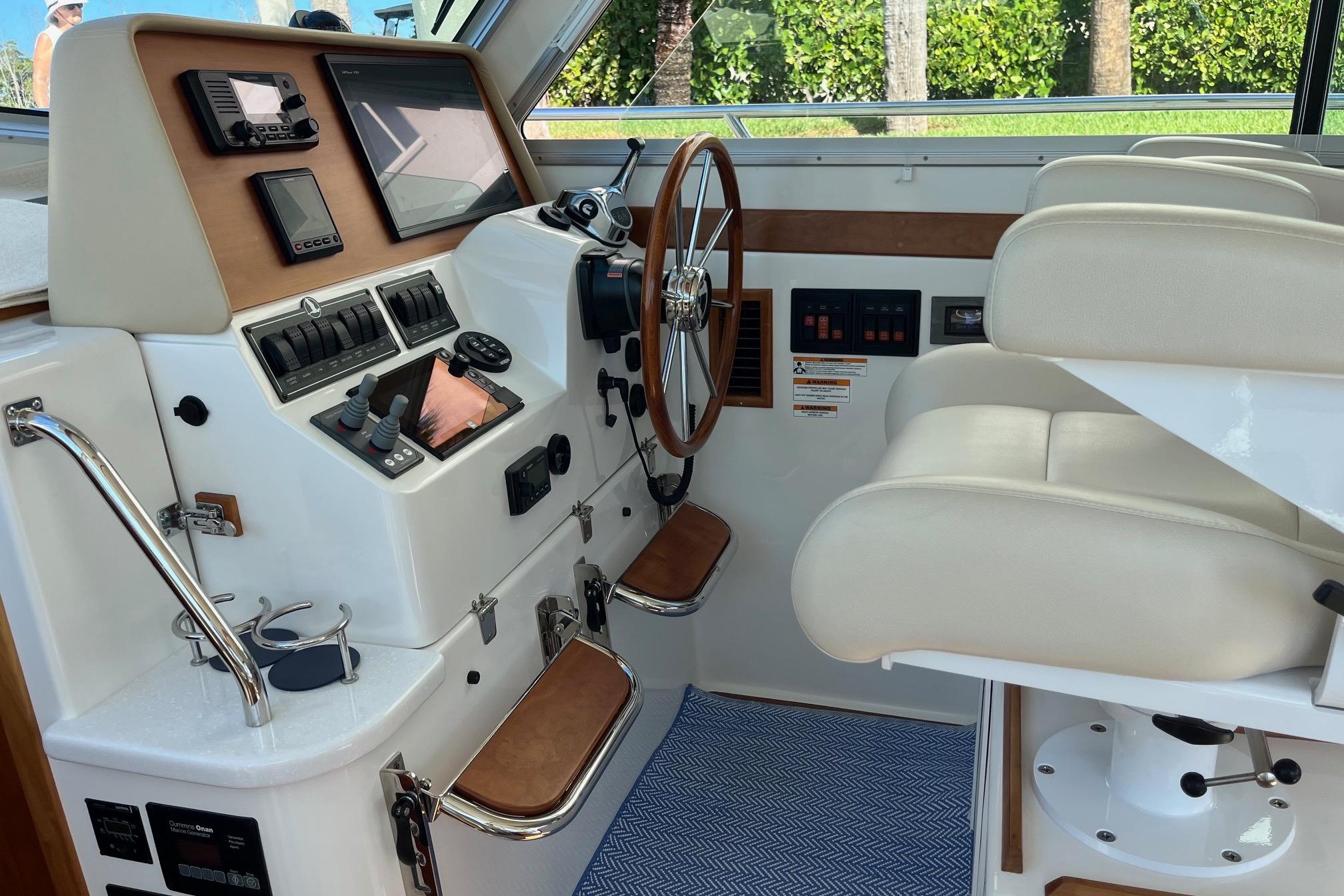 2017 Back Cove 37 helm with modern controls, wooden steering wheel, and comfortable seating.