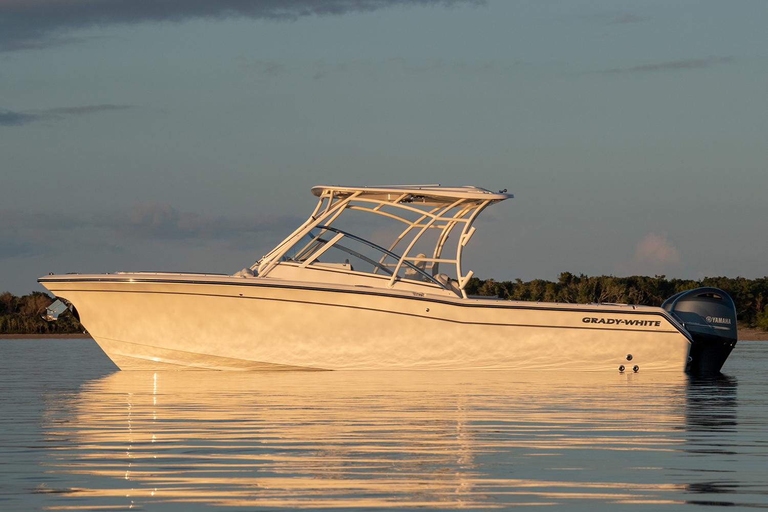 Manufacturer Provided Image: 2023 Grady-White Freedom 275 boat on calm water at sunset.