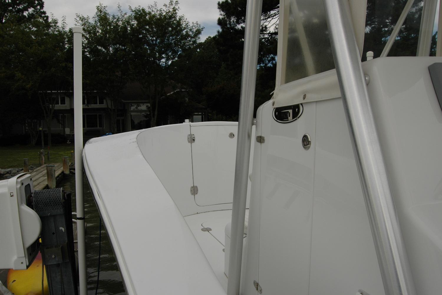 2013 Composite Yacht 26, white deck view, docked near waterfront homes.