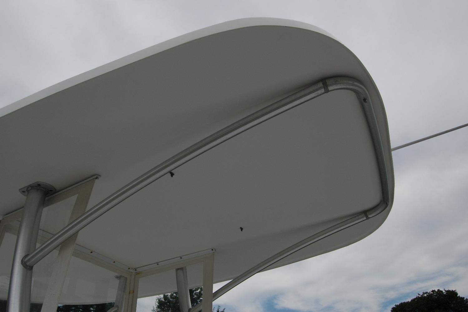 Close-up of Composite Yacht 26 hardtop, 2013 model, against cloudy sky.