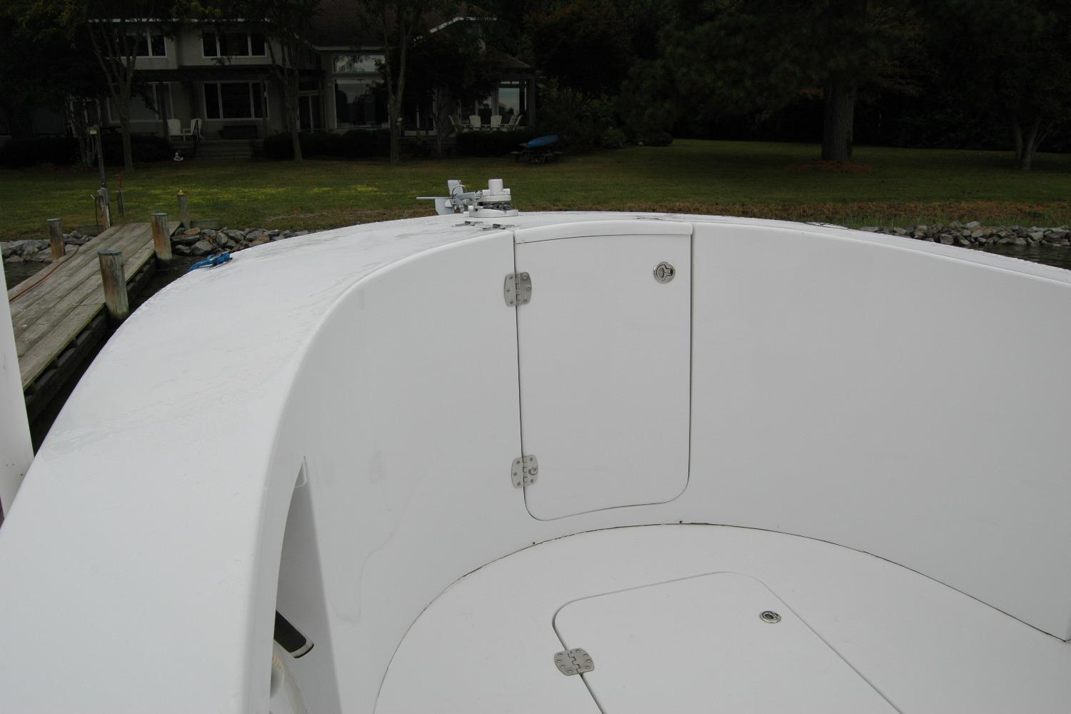 2013 Composite Yacht 26 model, white deck, docked near a grassy shoreline.