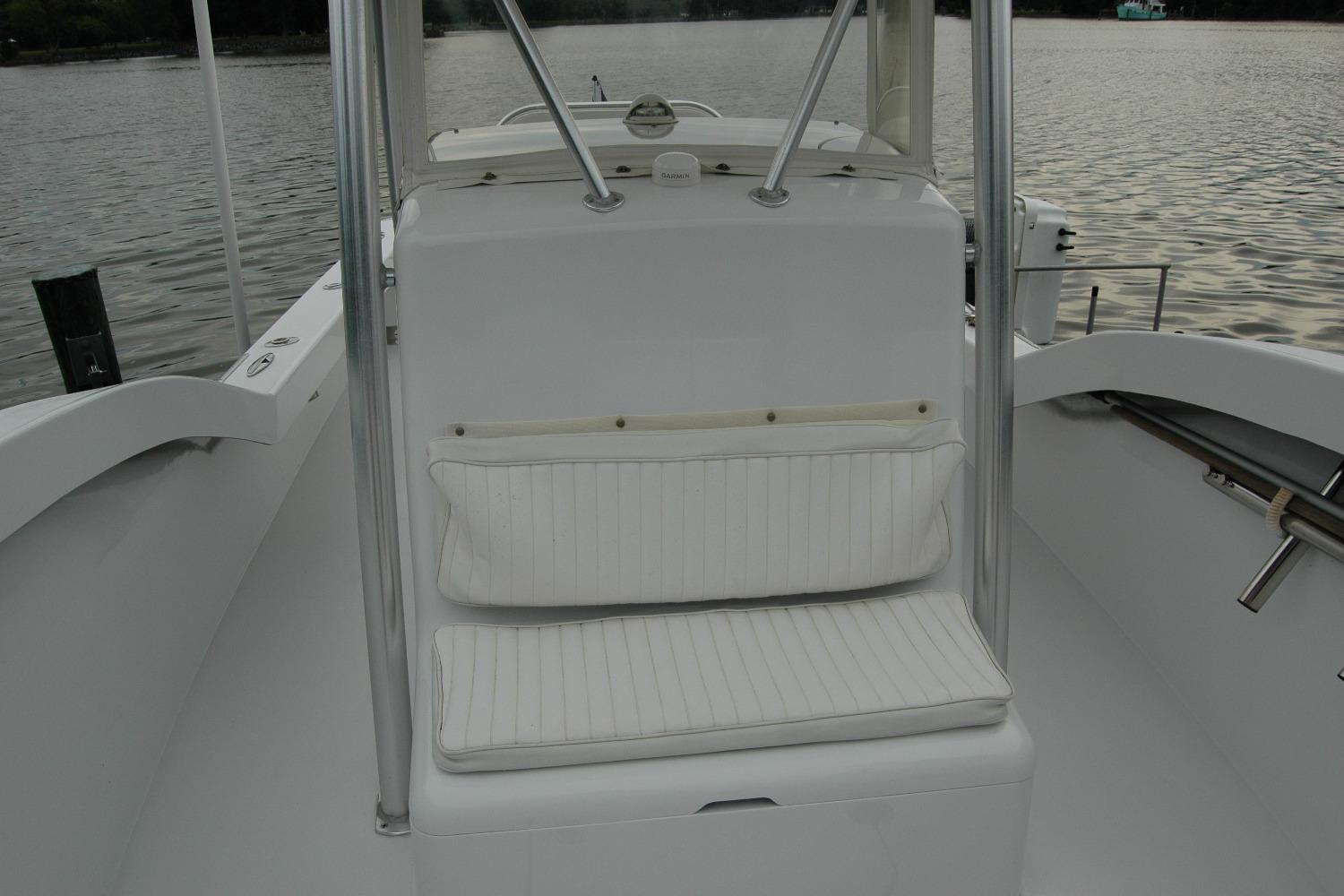 White seating area on a 2013 Composite Yacht 26, with water in the background.