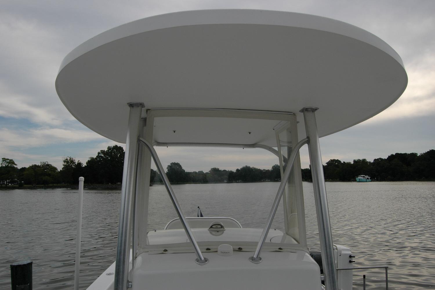 2013 Composite Yacht 26 on calm water, featuring a sleek canopy and sturdy frame.