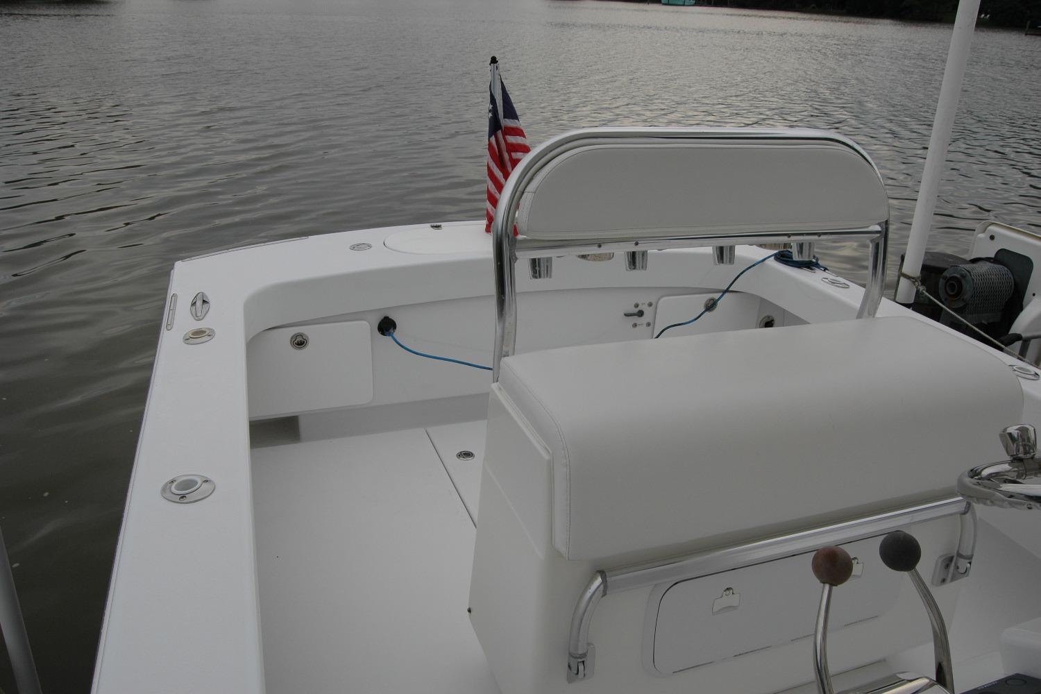 2013 Composite Yacht 26 on calm water, featuring a sleek white deck and American flag.