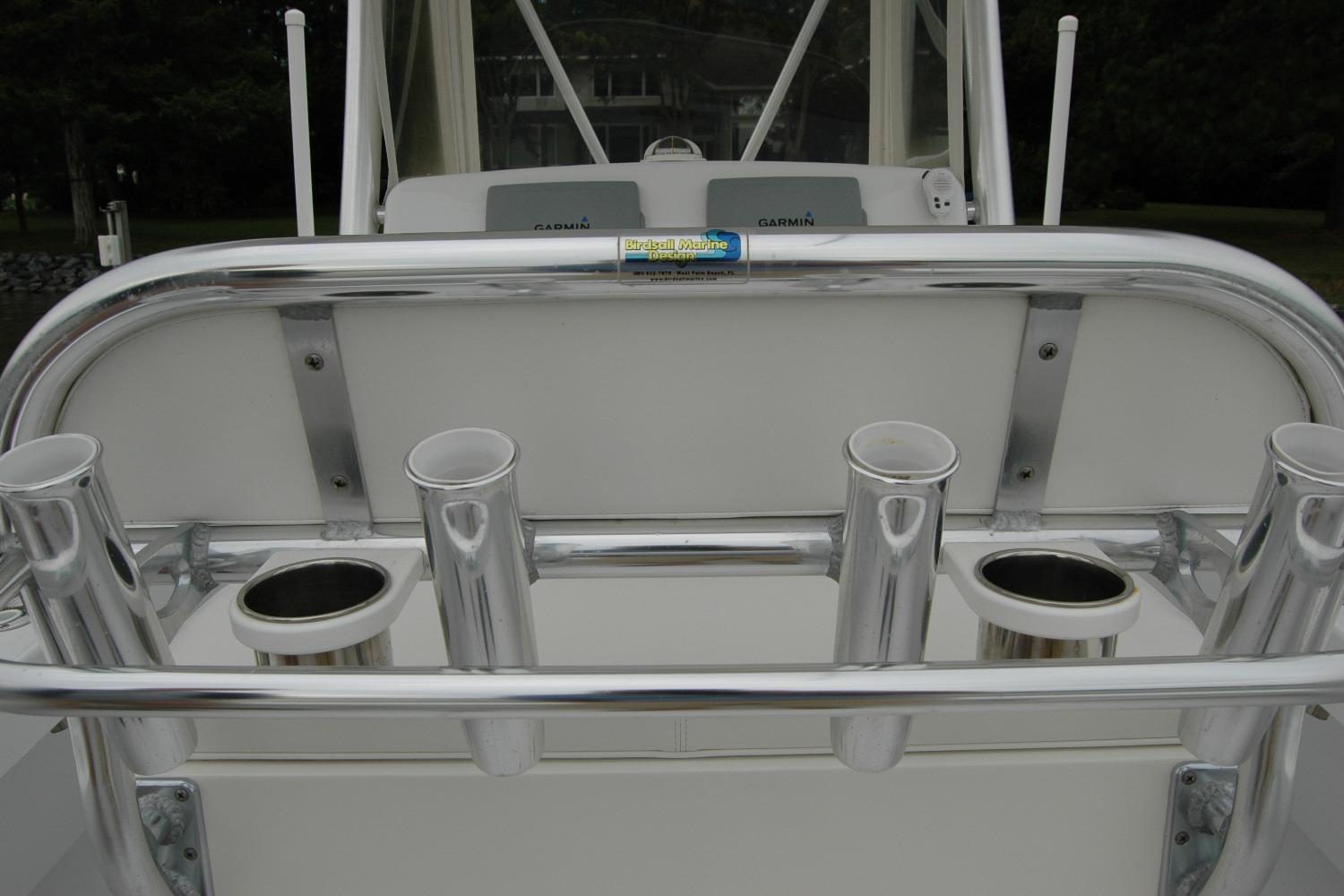 Rod holders on a 2013 Composite Yacht 26, featuring a sleek metal finish.