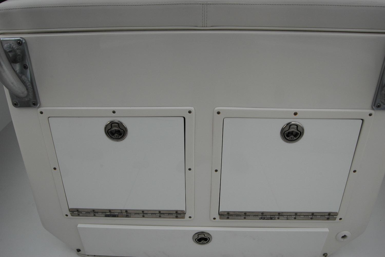 Storage compartments on a 2013 Composite Yacht 26, featuring secure latches and a sleek design.