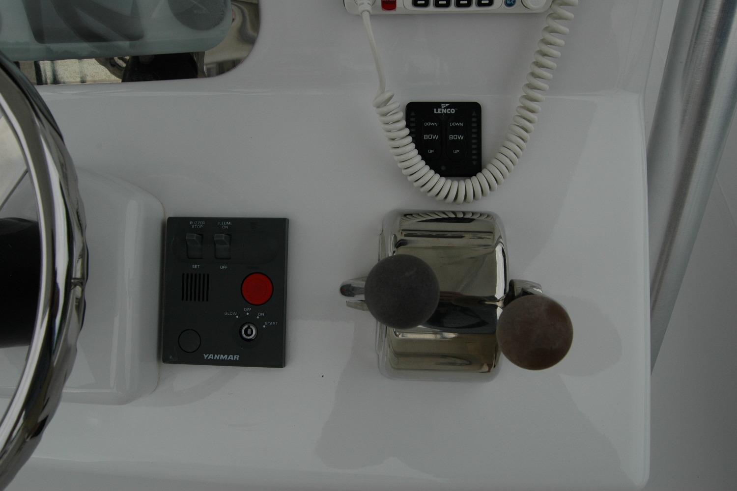 Control panel of a 2013 Composite Yacht 26, featuring steering and throttle controls.
