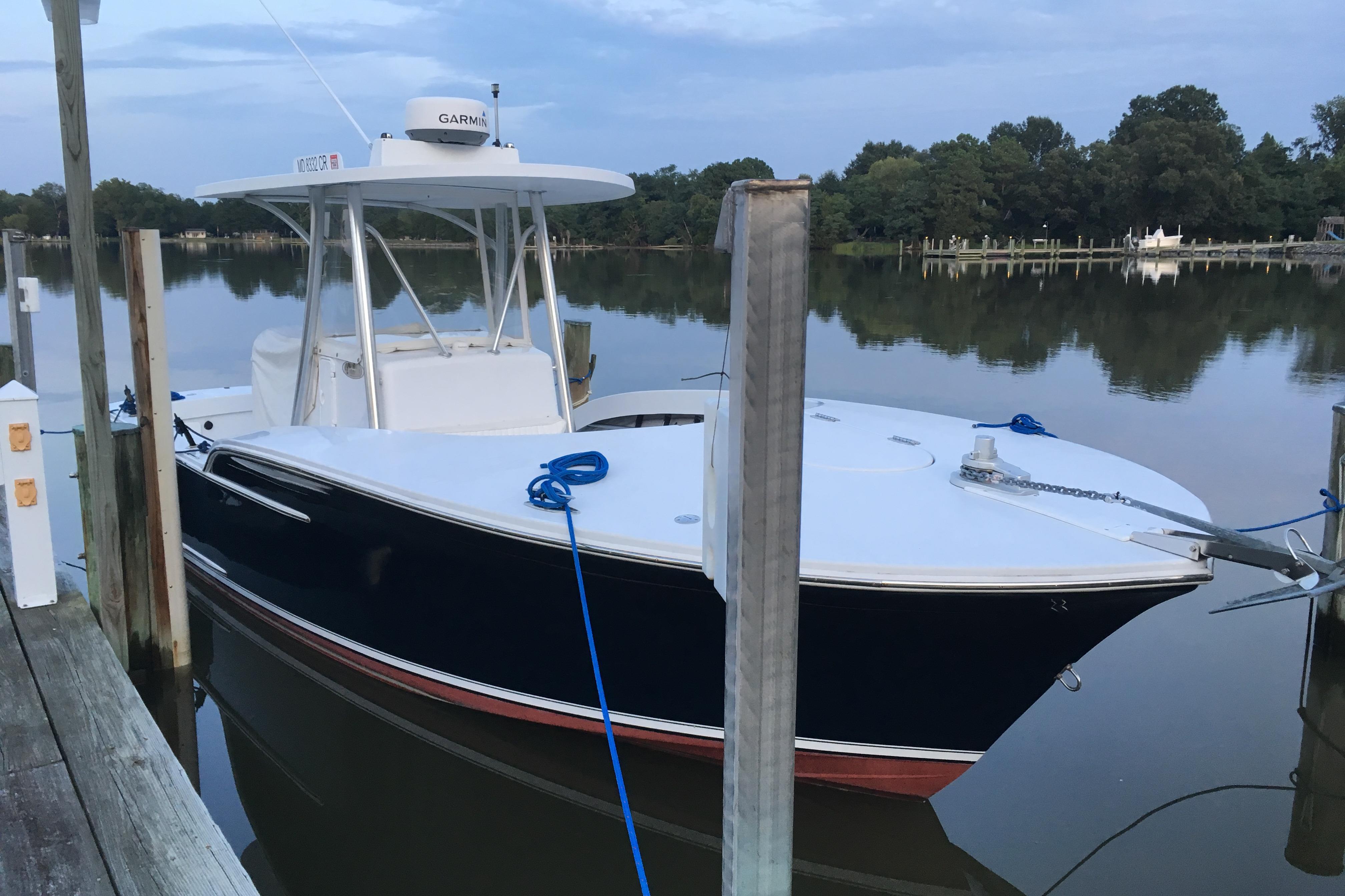 2013 Composite Yacht 26 docked on calm water, featuring sleek design and Garmin equipment.