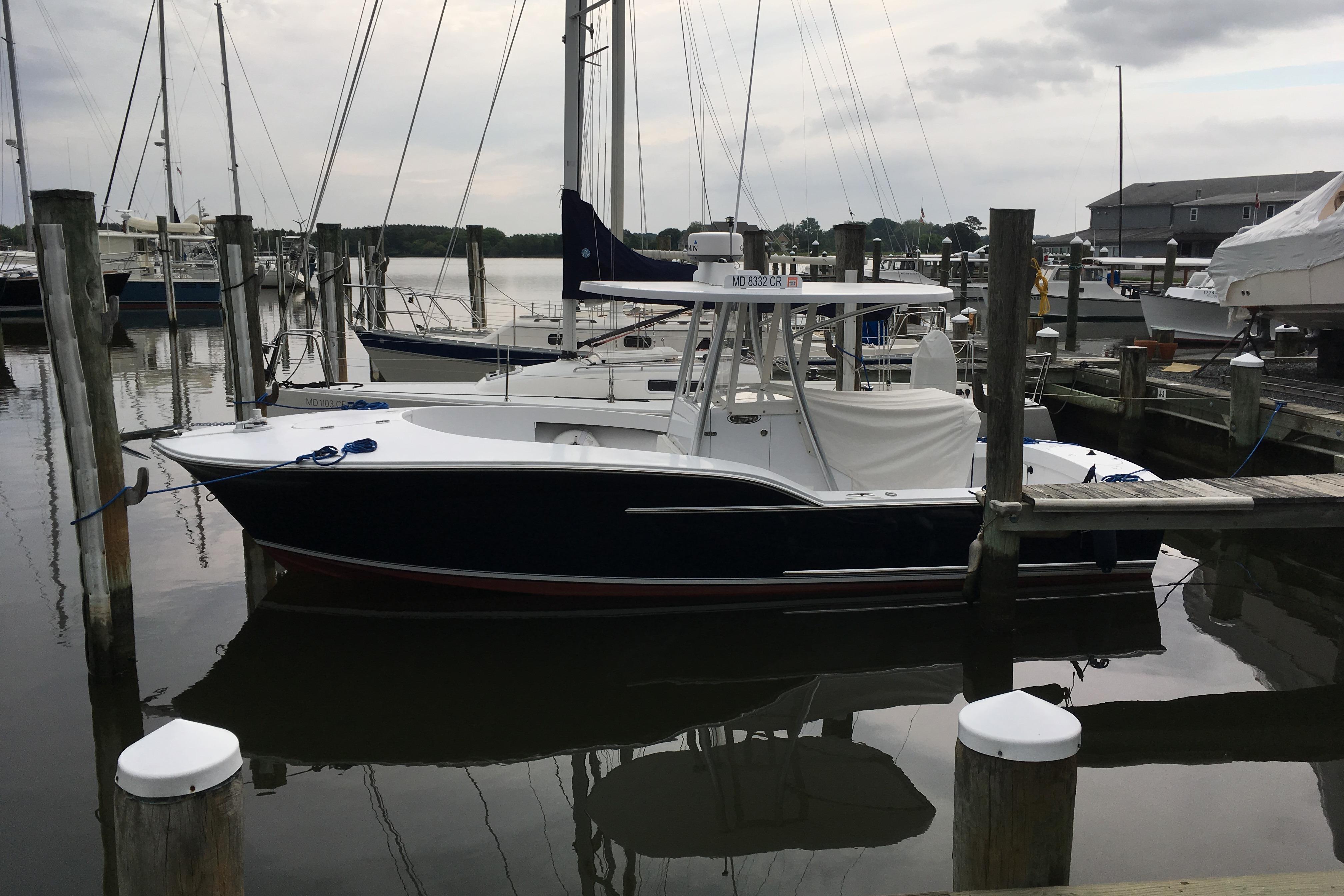 2013 Composite Yacht 26 docked at a marina, surrounded by other boats.