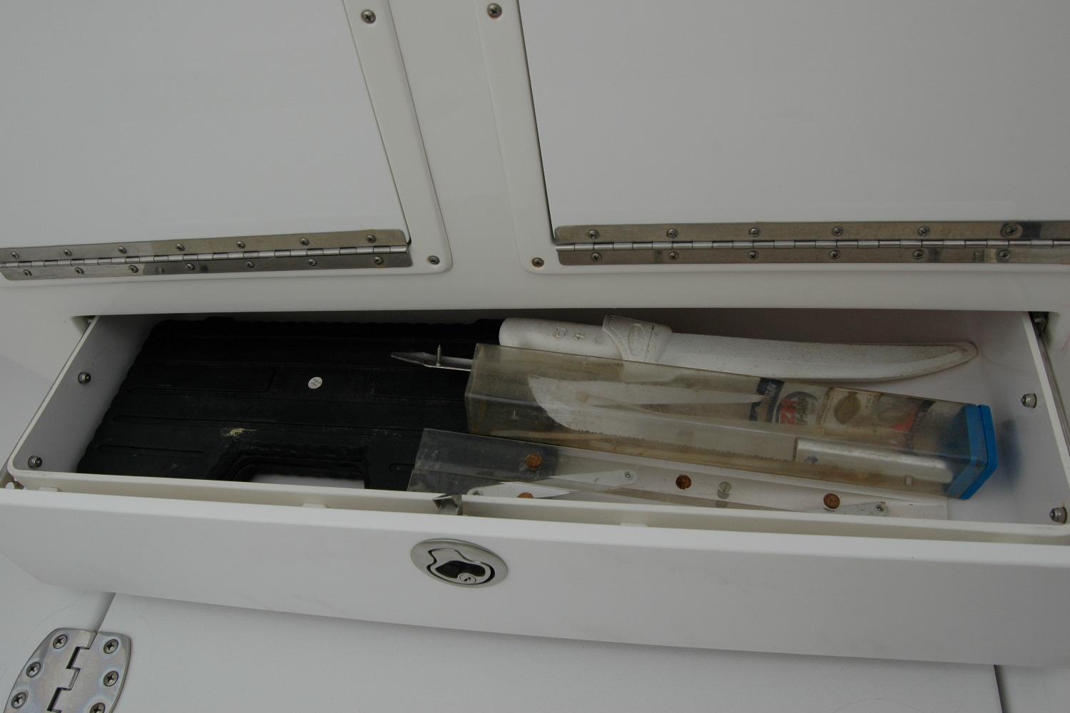 Storage compartment on 2013 Composite Yacht 26 with fishing gear and tools.