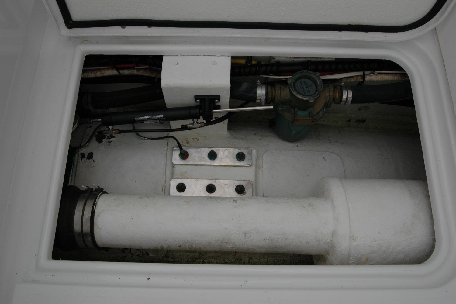 Engine compartment of a 2013 Composite Yacht 26, showing mechanical components and piping.