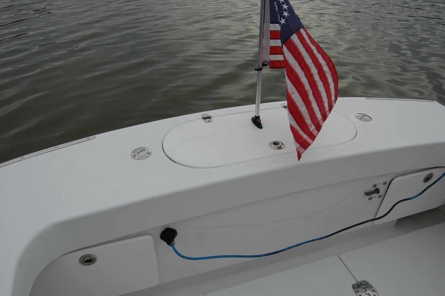 2013 Composite Yacht 26 with American flag on calm water.