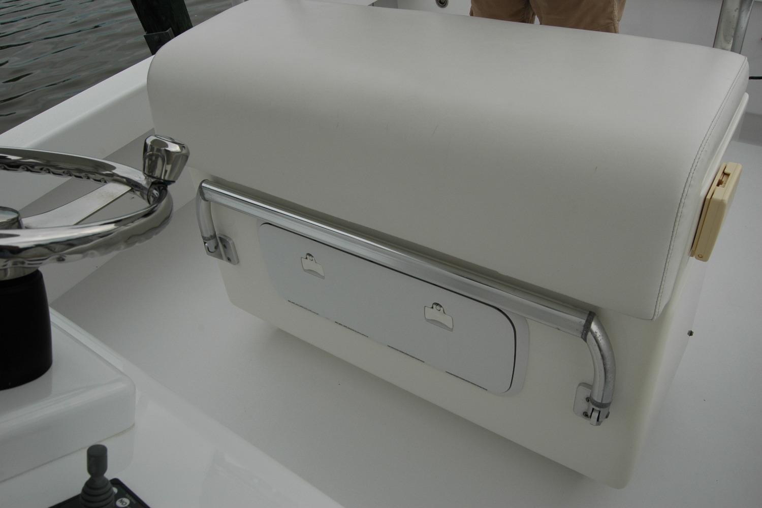 Steering area of 2013 Composite Yacht 26 with white seating and chrome details.