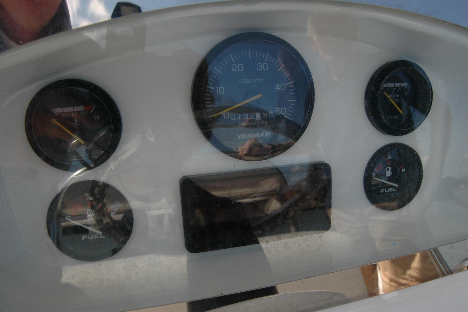 Dashboard of 2013 Composite Yacht 26 with fuel and temperature gauges.