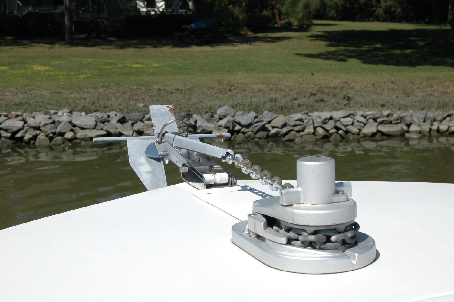 Anchor mechanism on 2013 Composite Yacht 26, near rocky shoreline.