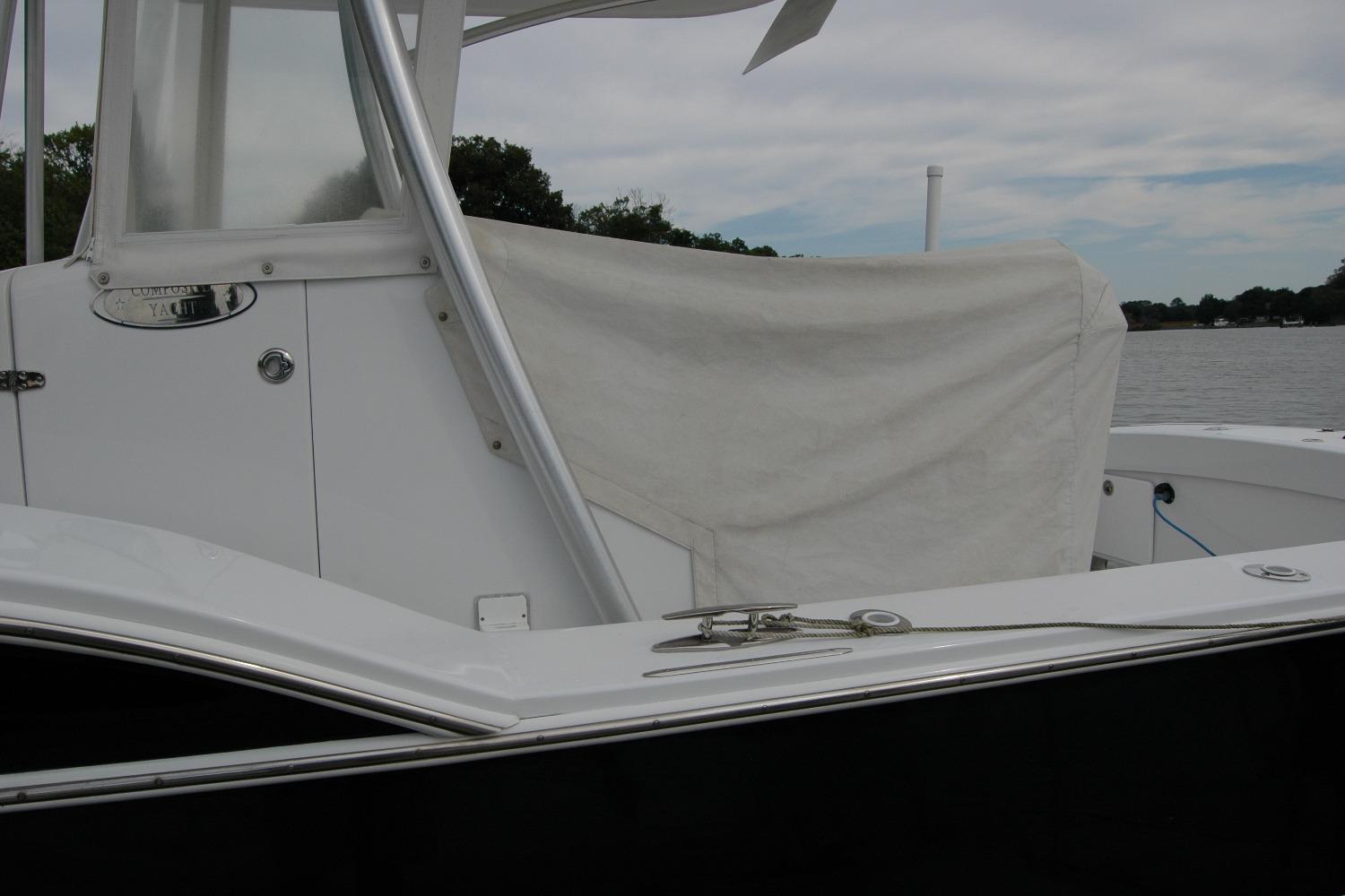 2013 Composite Yacht 26, white exterior, docked by a calm river.