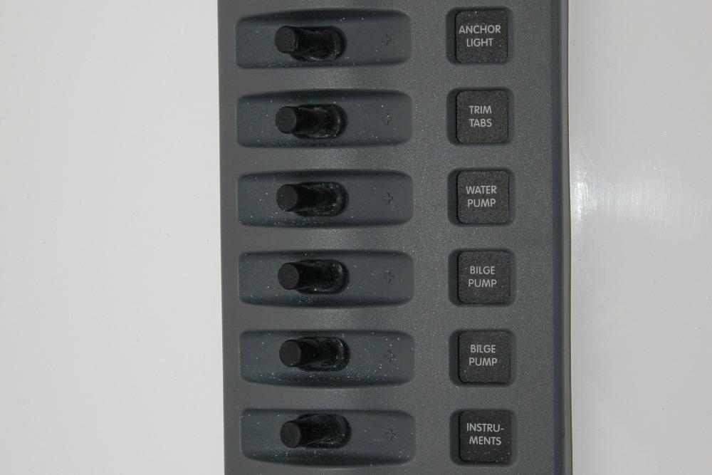 Control panel of a 2013 Composite Yacht 26 with labeled switches for various functions.