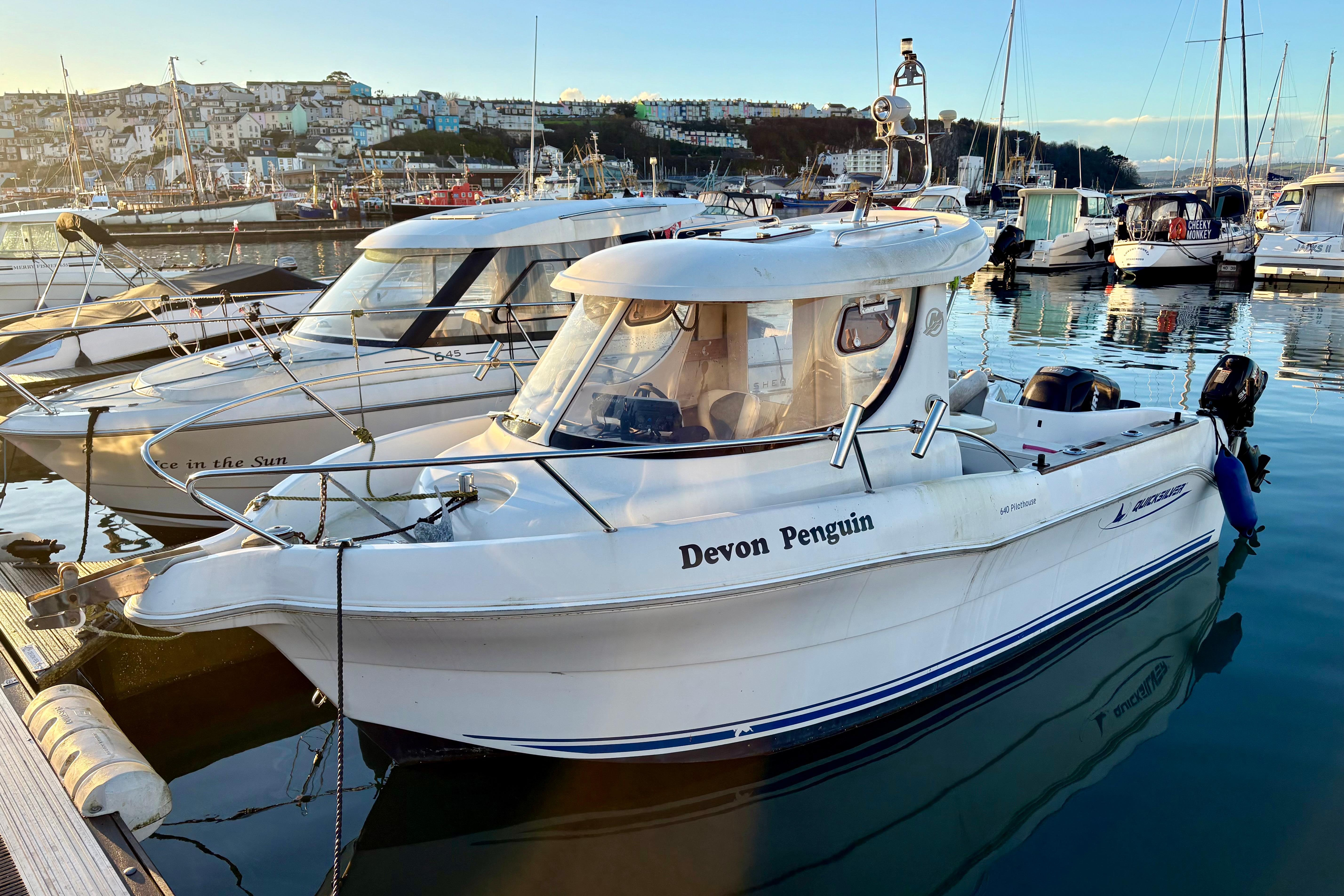 2008 Quicksilver 640 Pilothouse boat docked in a scenic marina.