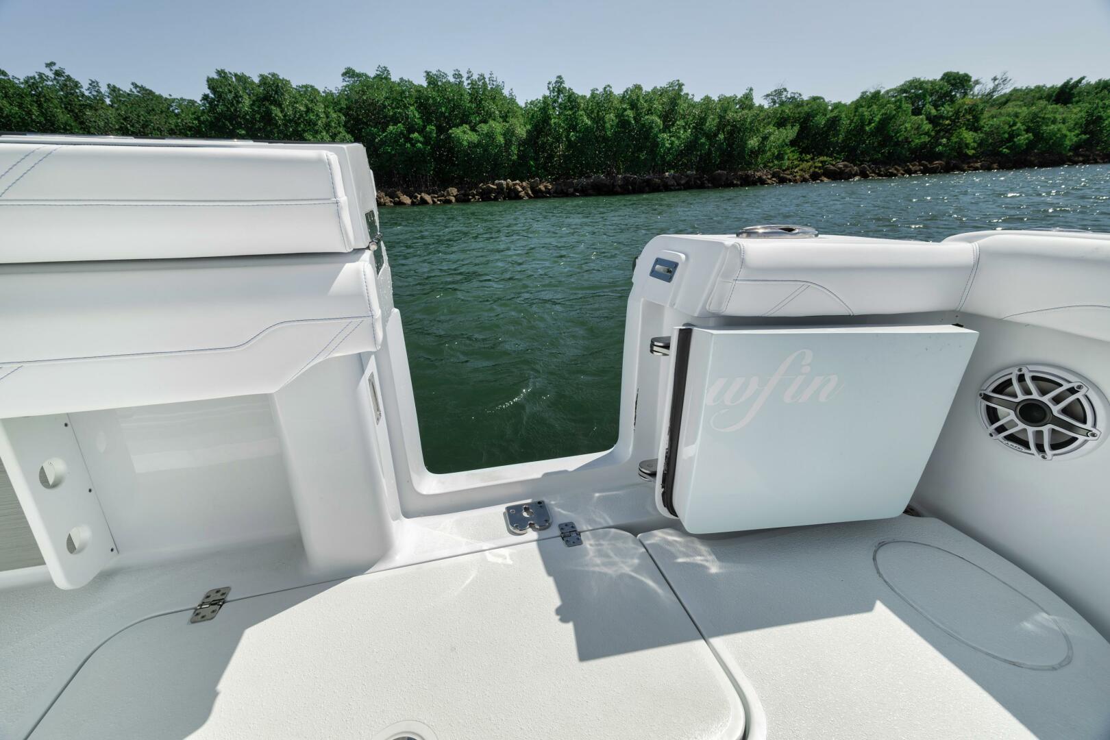Yellowfin-36 Offshore 2025-36 Offshore FL-US-2025 Yellowfin 36 Offshore boat interior with open door, near water and greenery.-9817861 | Thumbnail