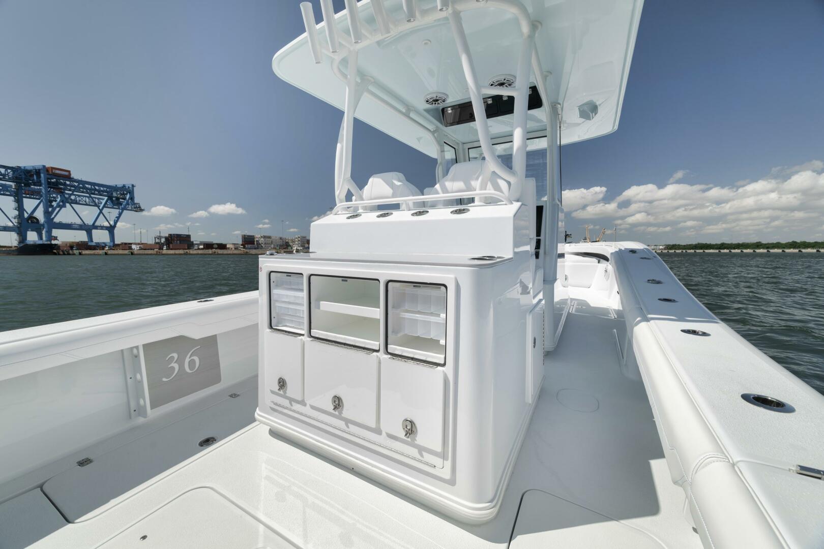 Yellowfin-36 Offshore 2025-36 Offshore FL-US-2025 Yellowfin 36 Offshore boat interior with storage compartments, docked near industrial area.-9817861 | Thumbnail