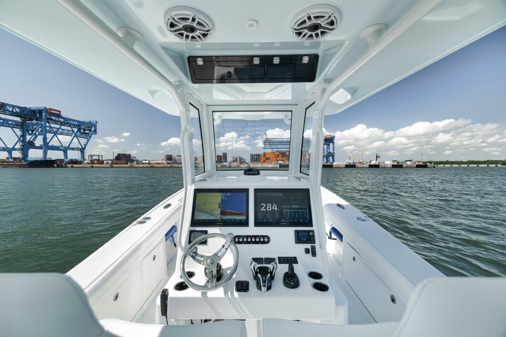 Yellowfin-36 Offshore 2025-36 Offshore FL-US-2025 Yellowfin 36 Offshore boat cockpit with modern controls, navigating near industrial port.-9817861 | Thumbnail