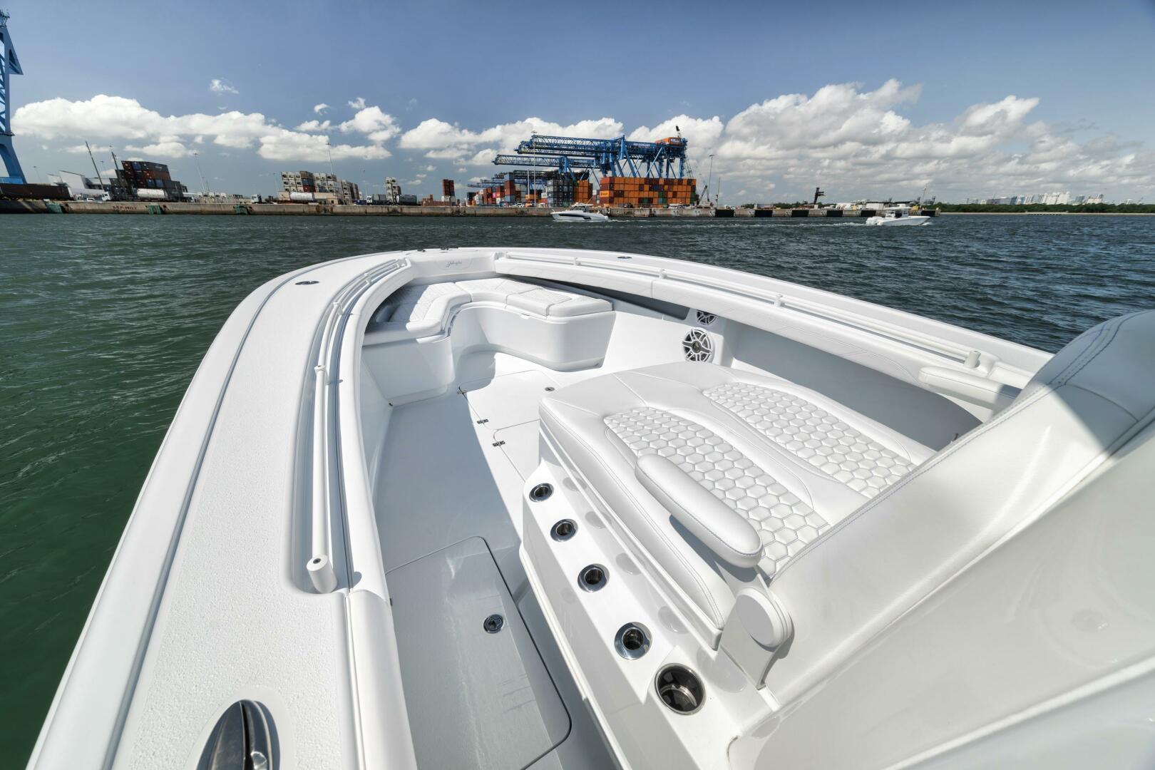 Yellowfin-36 Offshore 2025-36 Offshore FL-US-2025 Yellowfin 36 Offshore boat with white seating, docked near an industrial port.-9817861 | Thumbnail