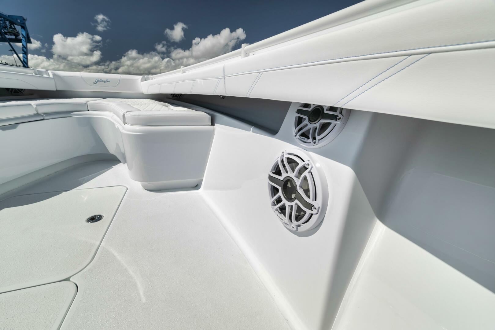 Yellowfin-36 Offshore 2025-36 Offshore FL-US-2025 Yellowfin 36 Offshore boat interior with speakers and seating under a cloudy sky.-9817861 | Thumbnail