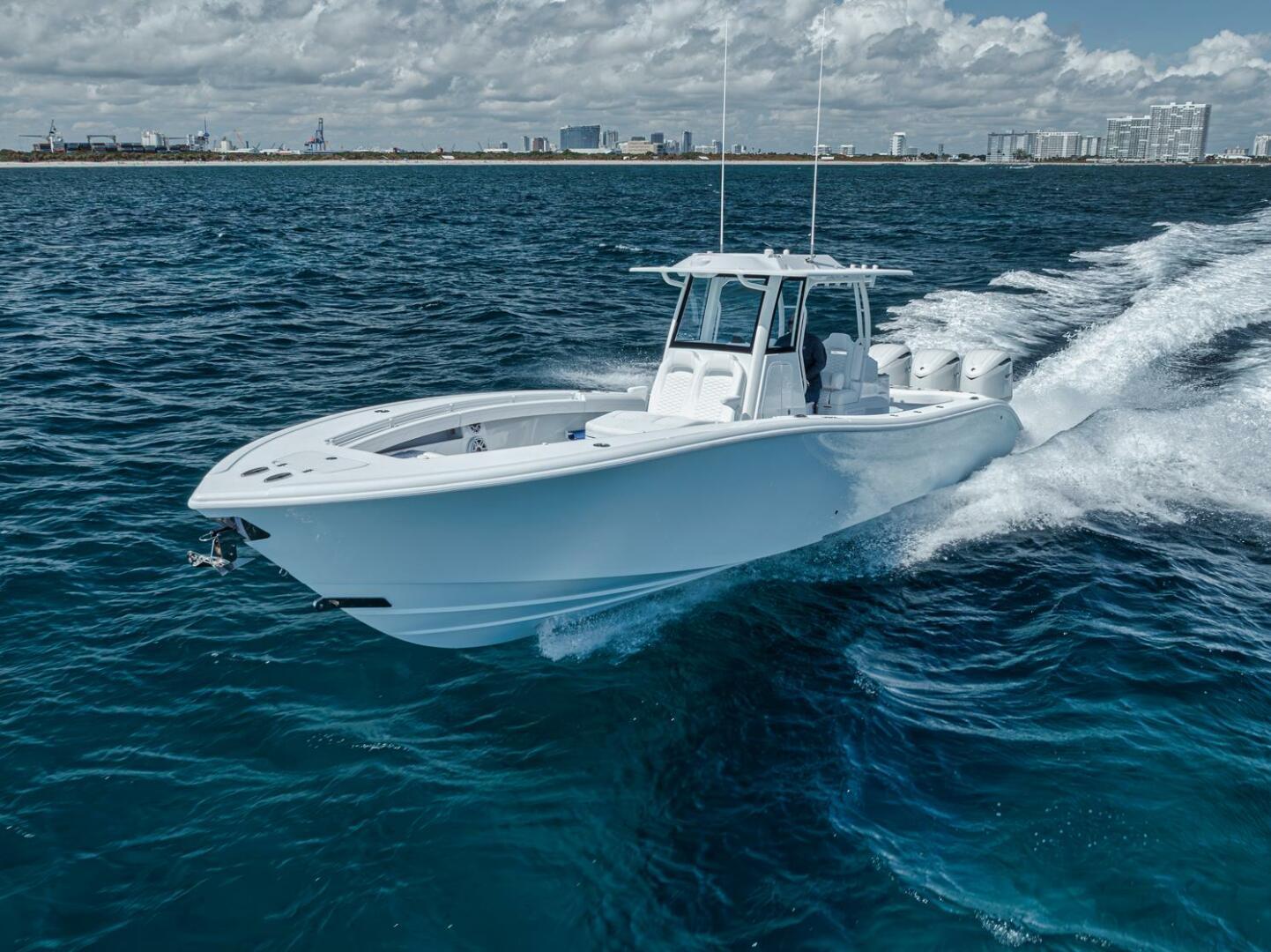 Yellowfin-36 Offshore 2025-36 Offshore FL-US-2025 Yellowfin 36 Offshore boat cruising on open ocean with city skyline in background.-9817861 | Thumbnail