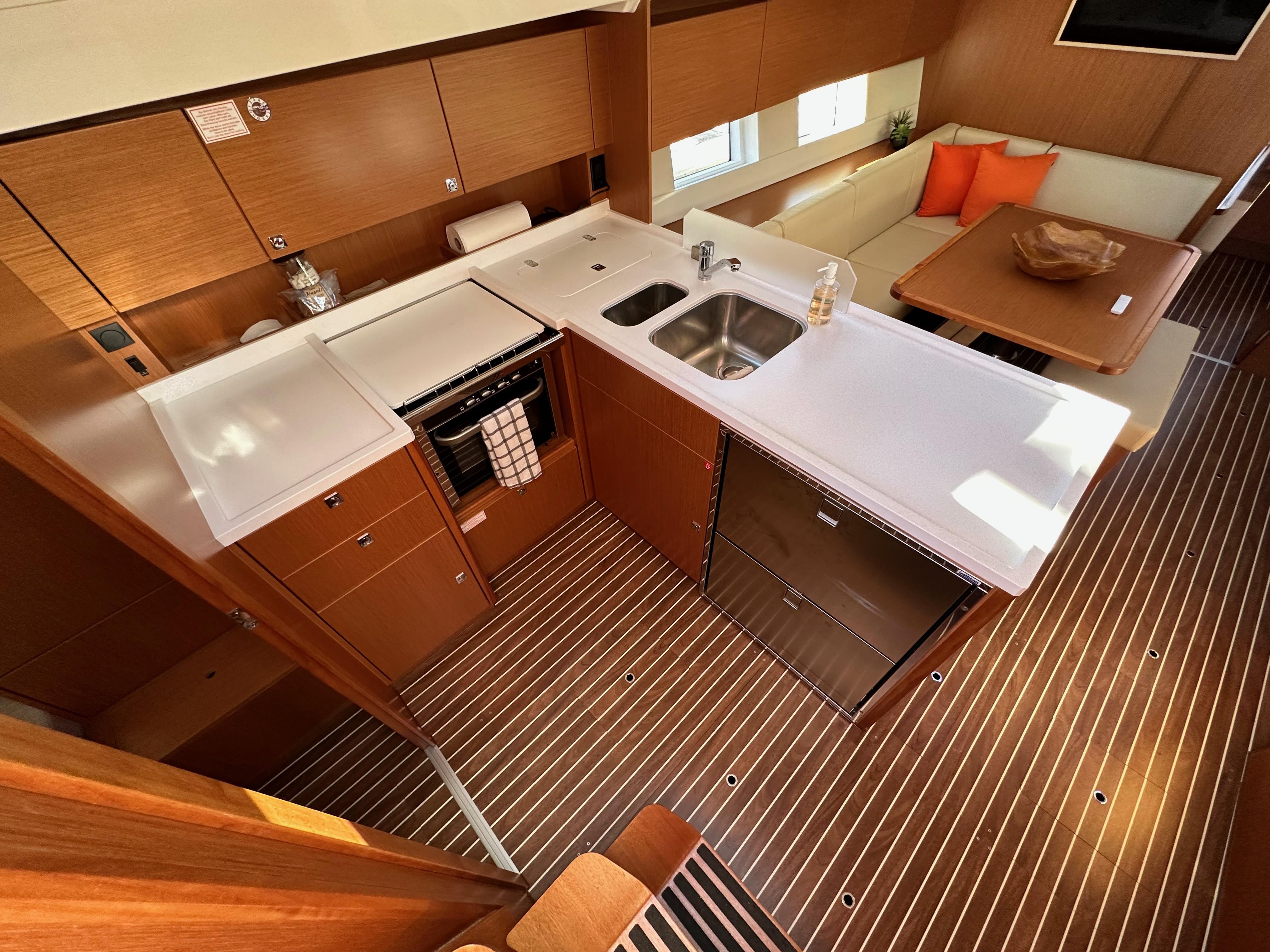 Bavaria-C45 2024-In stock and availabe now CA-US-Modern kitchen interior of 2024 Bavaria C45 yacht with sleek wood finish and compact design.-9712200 | Thumbnail