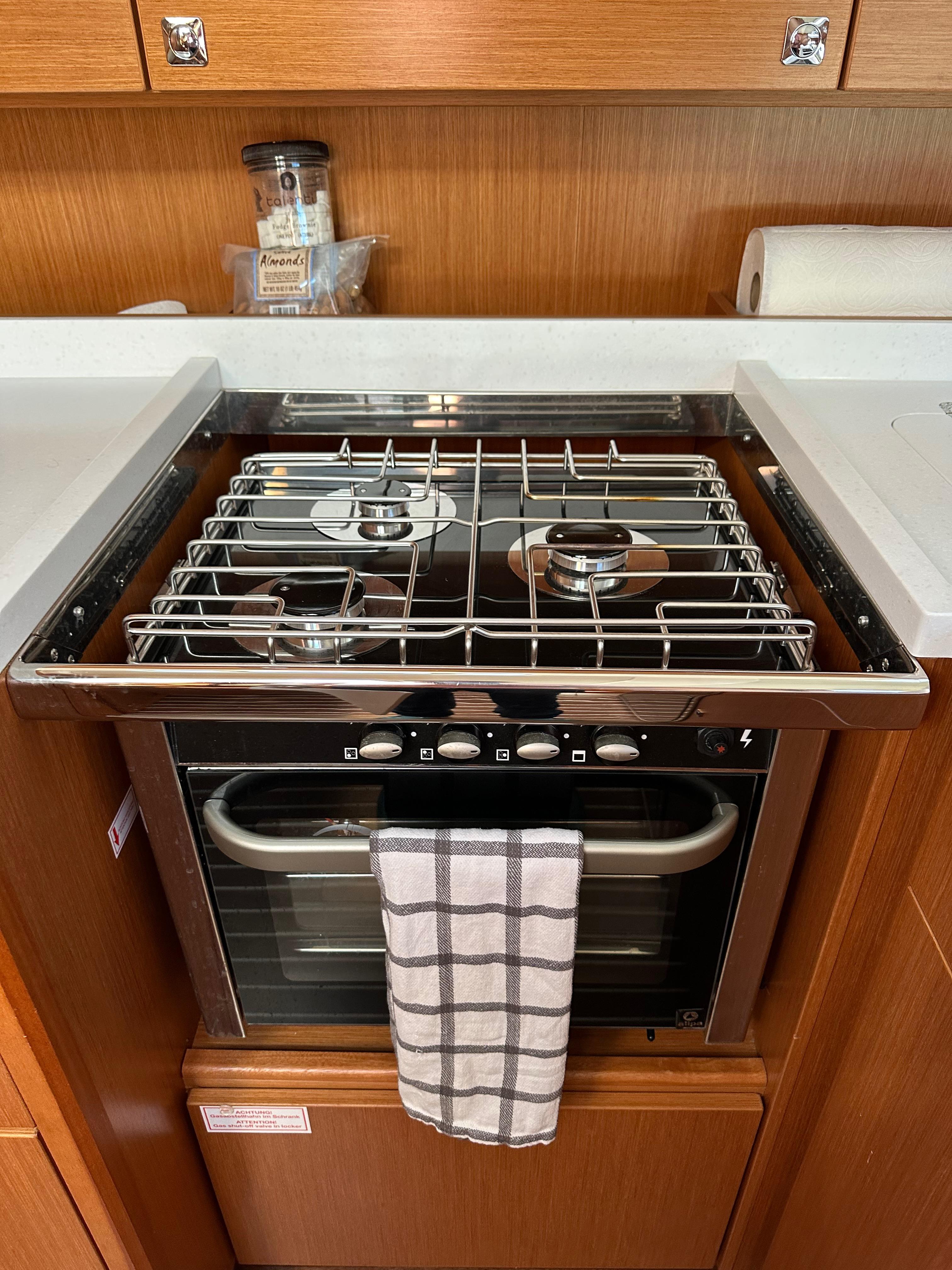 Bavaria-C45 2024-In stock and availabe now CA-US-2024 Bavaria C45 yacht kitchen with stove and oven, featuring a towel and wooden cabinetry.-9712200 | Thumbnail