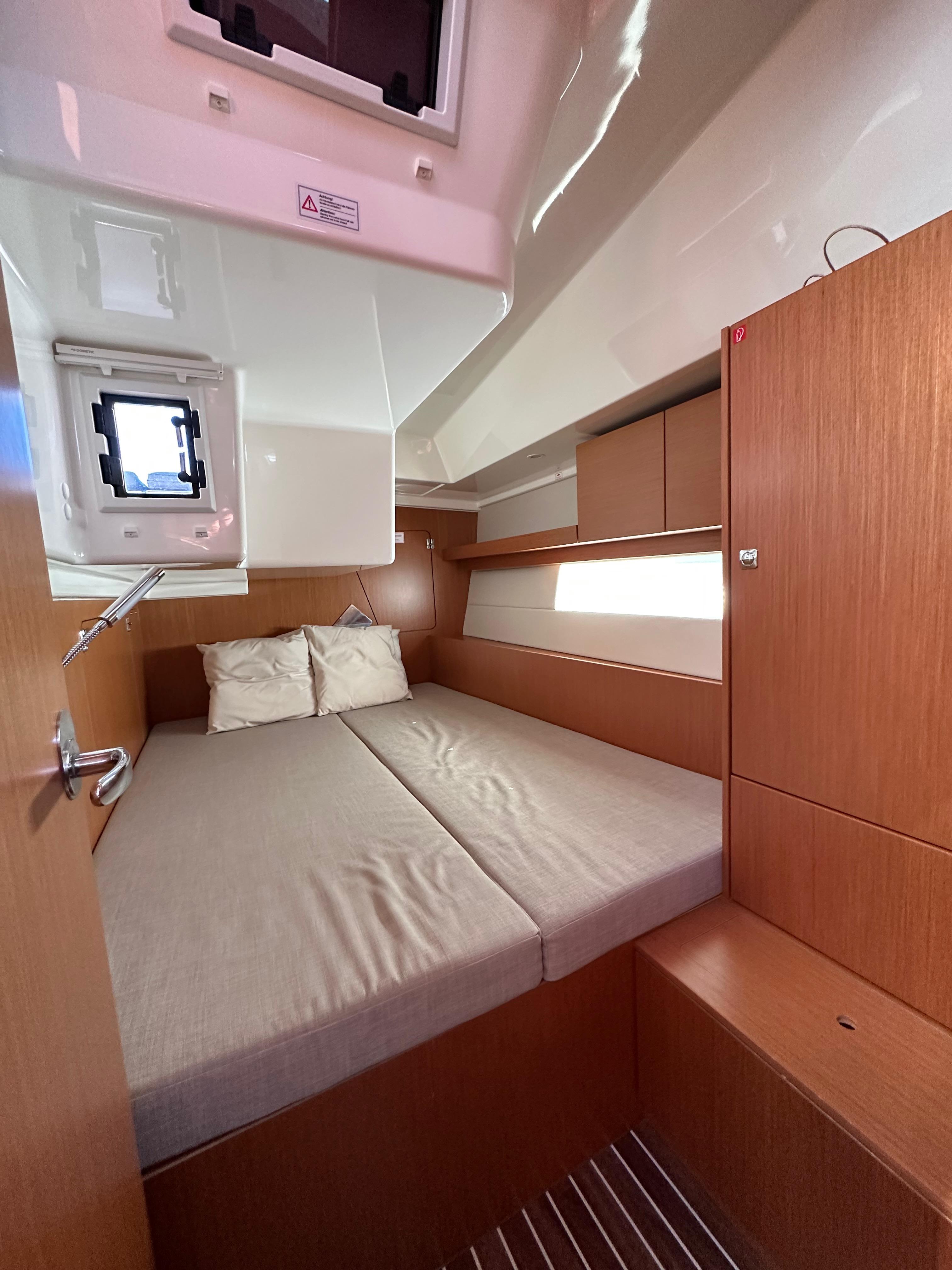 Bavaria-C45 2024-In stock and availabe now CA-US-2024 Bavaria C45 yacht cabin with cozy bed and wooden interior design.-9712200 | Thumbnail